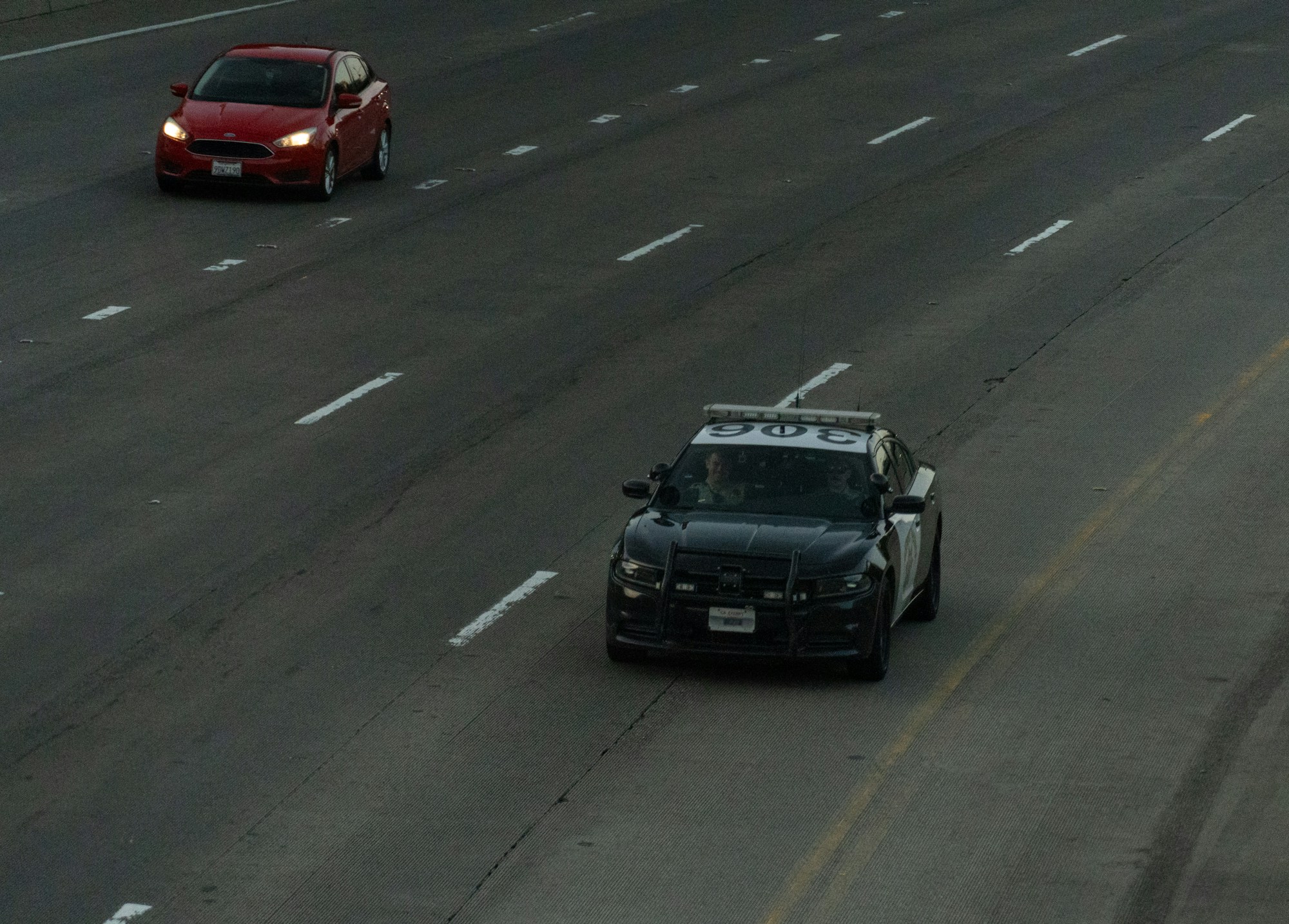 Police car and another vehicle on the highway during a traffic stop