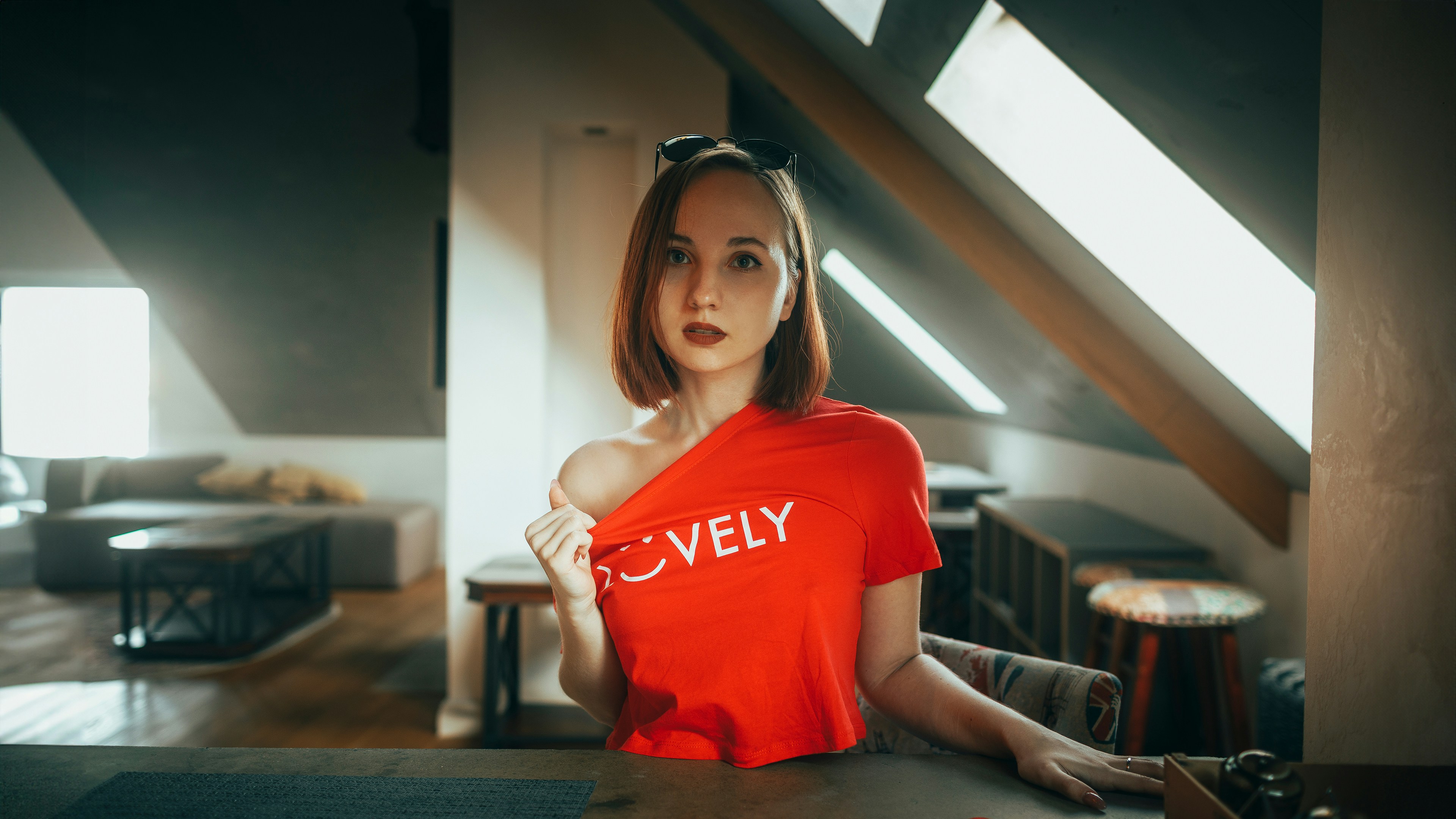 Young woman in red shirt with 'lovely' text.