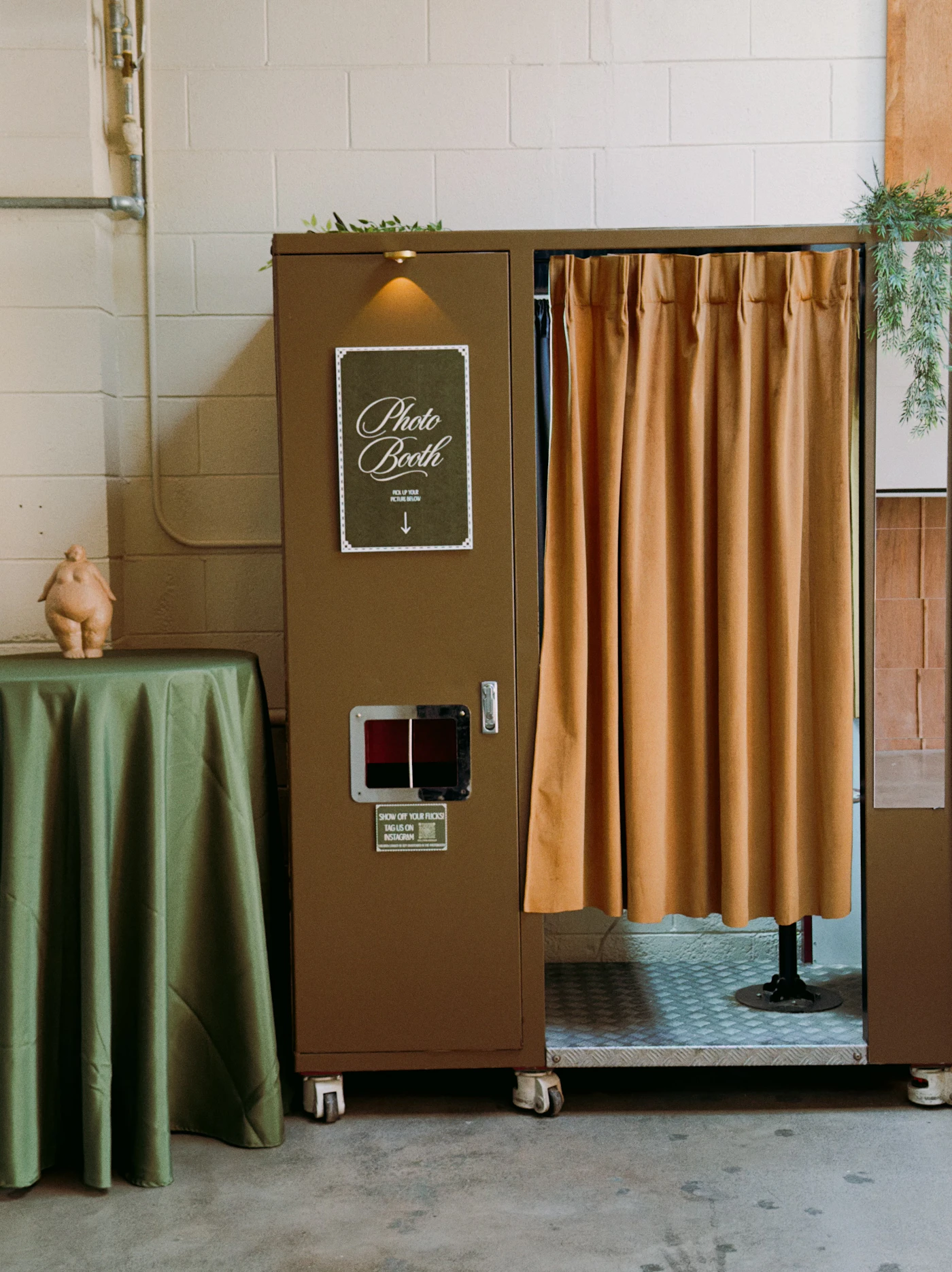 How to create a DIY photo booth with vintage props — Guests posing with DIY vintage props at a wedding reception.