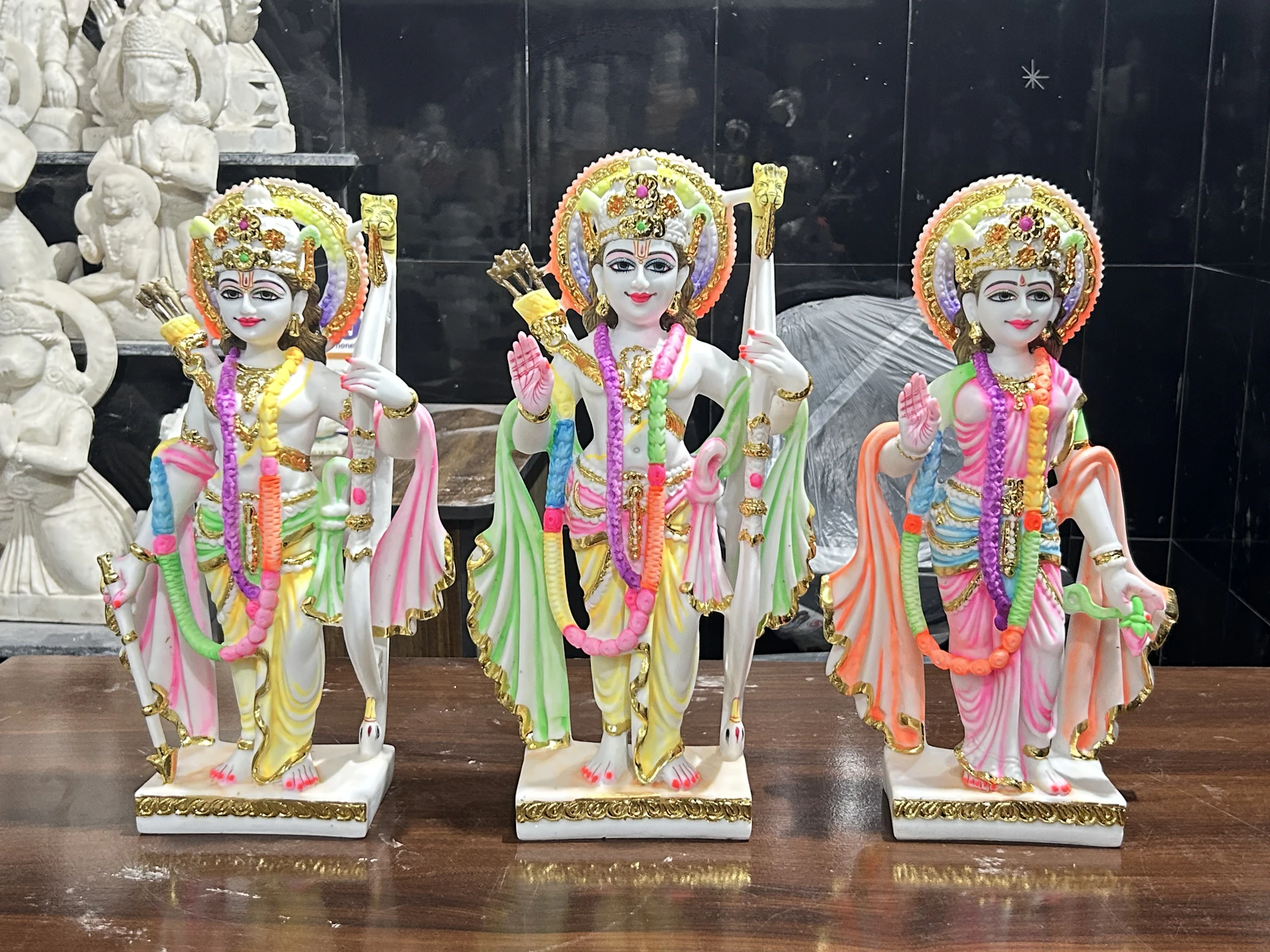Colorful marble statues of lord rama, lakshmana, and sita.