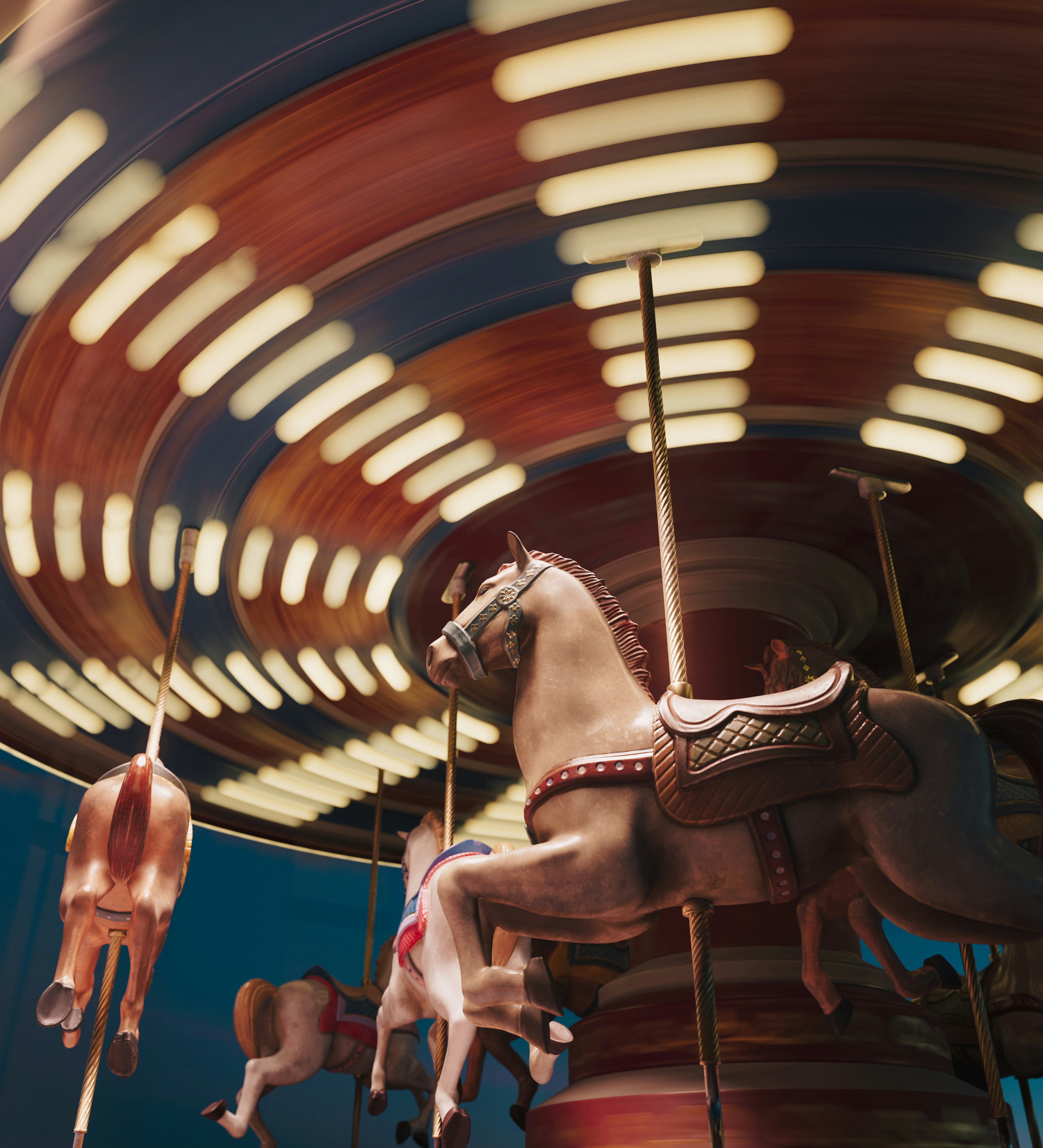 Carousel horses spinning with blurred lights at night