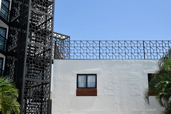 Modern black geometric metal railing on a building exterior