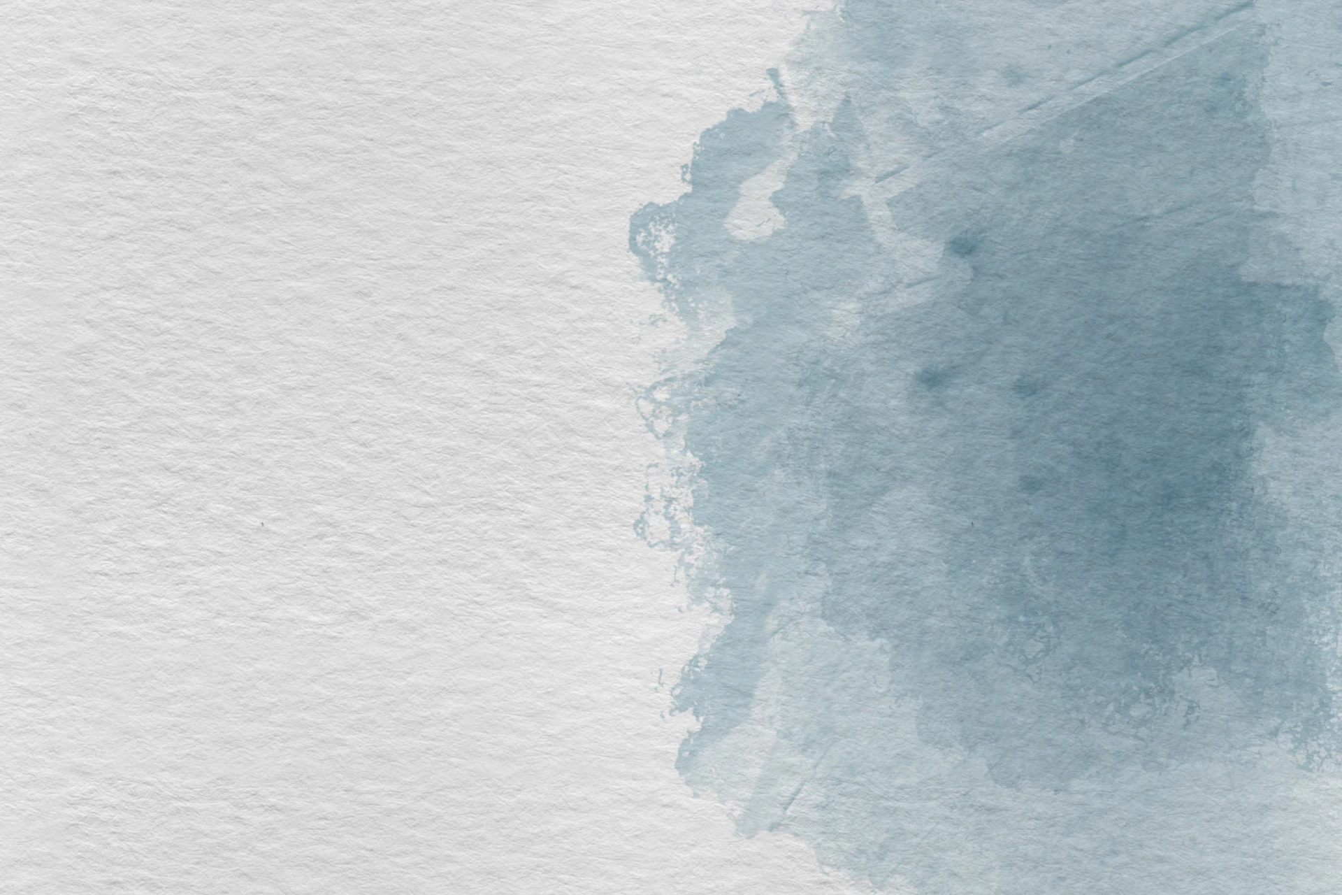 Blue watercolor splash on textured white paper