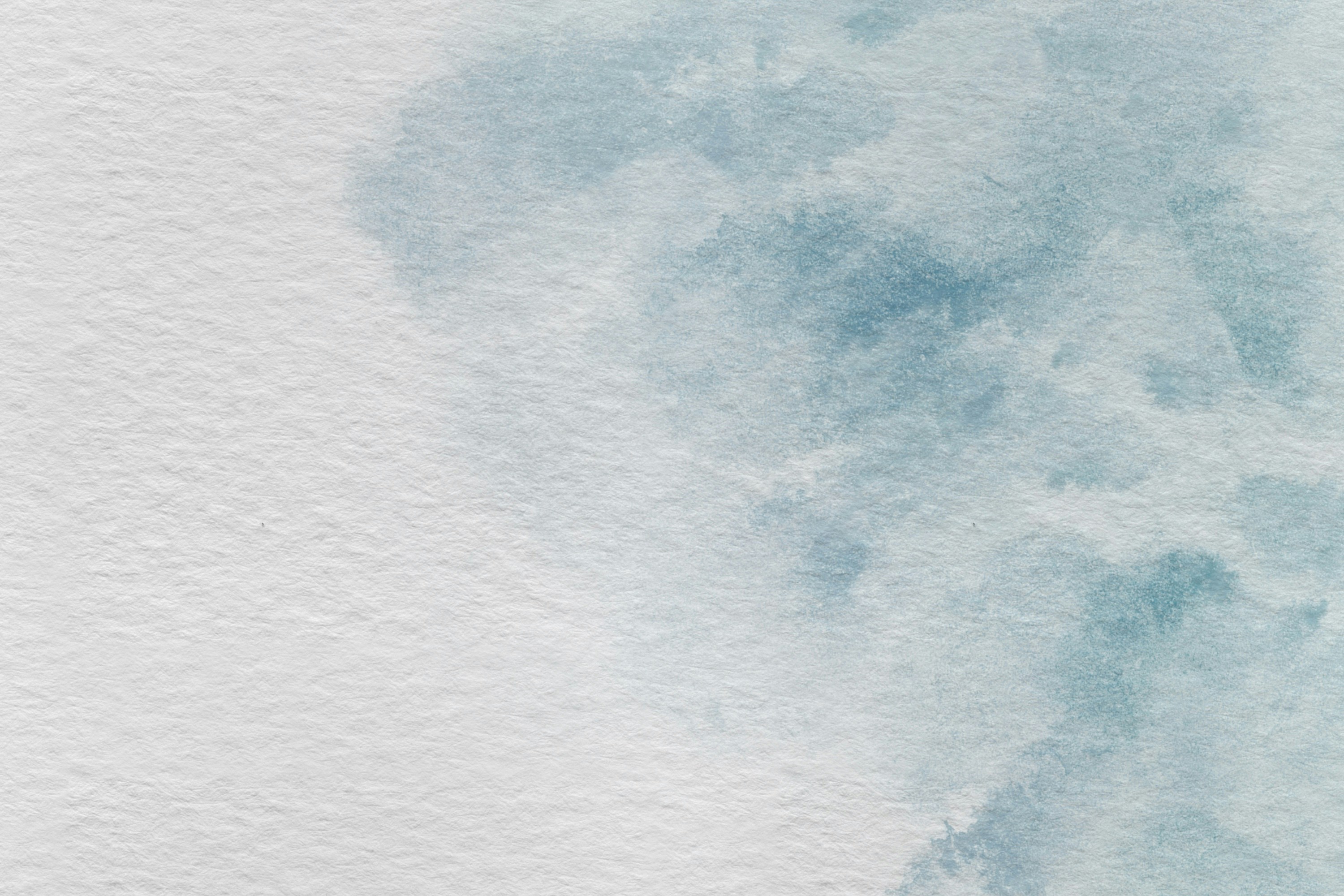 Abstract blue watercolor wash on textured paper