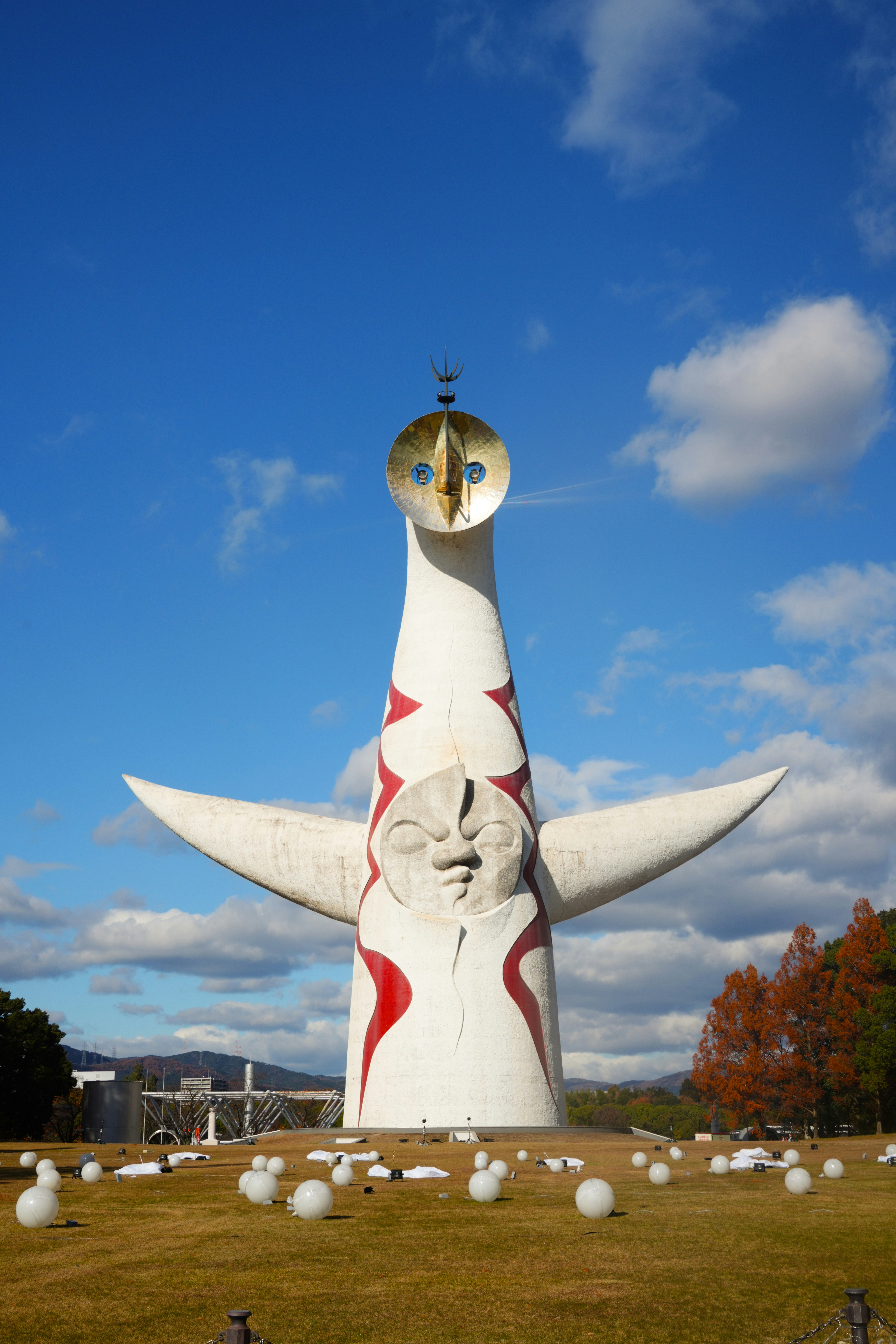 Tower of the sun sculpture against a blue sky.