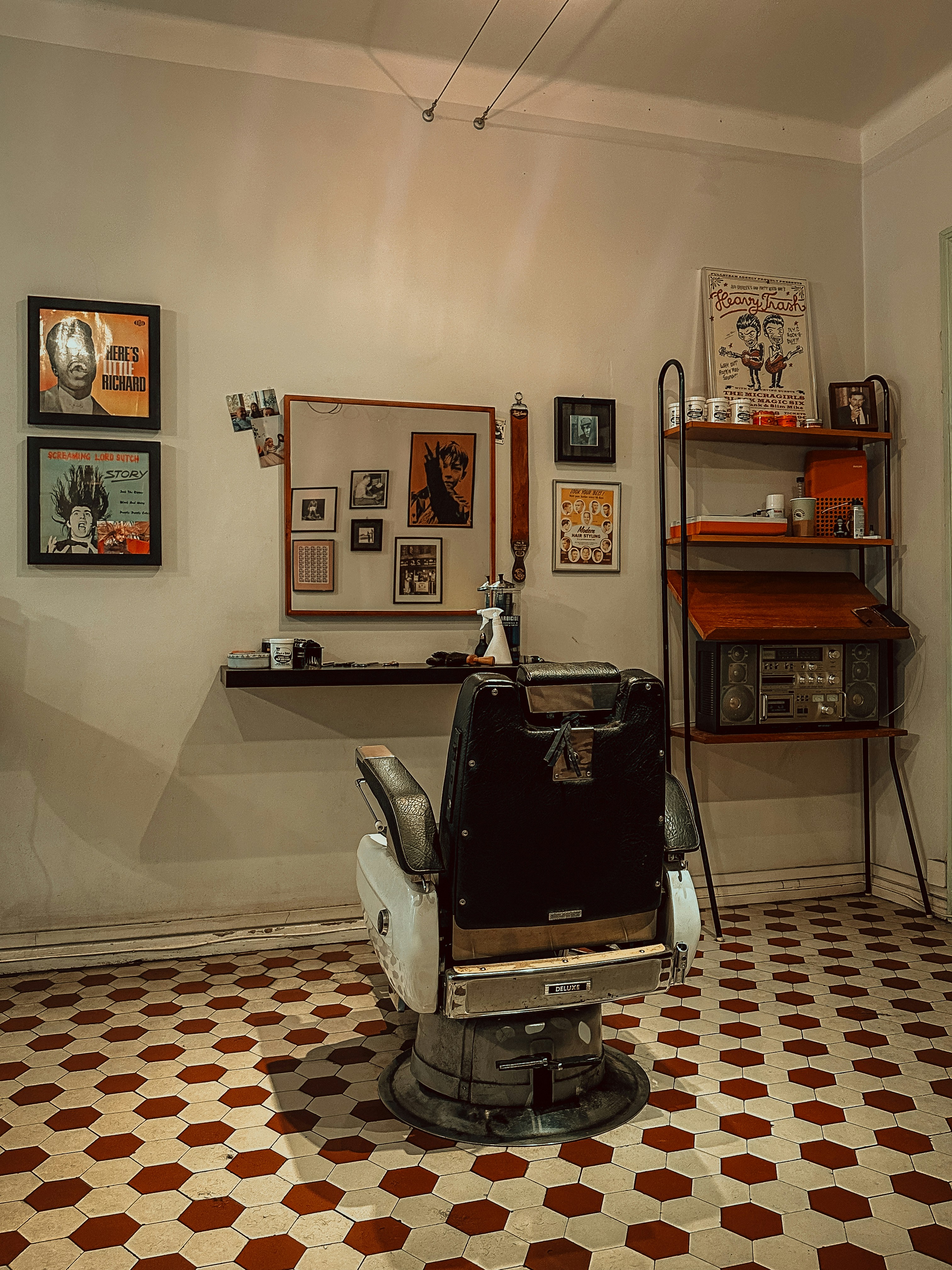 Vintage barber chair in a room with artwork.
