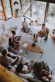 Group meditating in a bright, modern room.