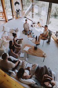 Group meditating in a bright, modern room.