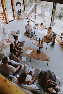Group meditating in a bright, modern room.