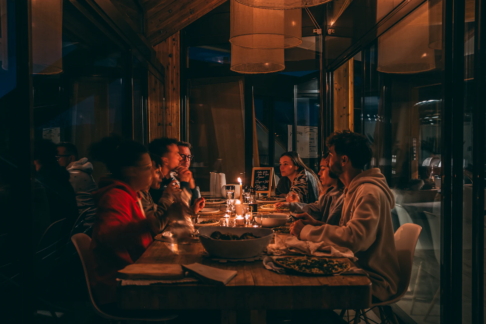 Friends around a dinner table at night