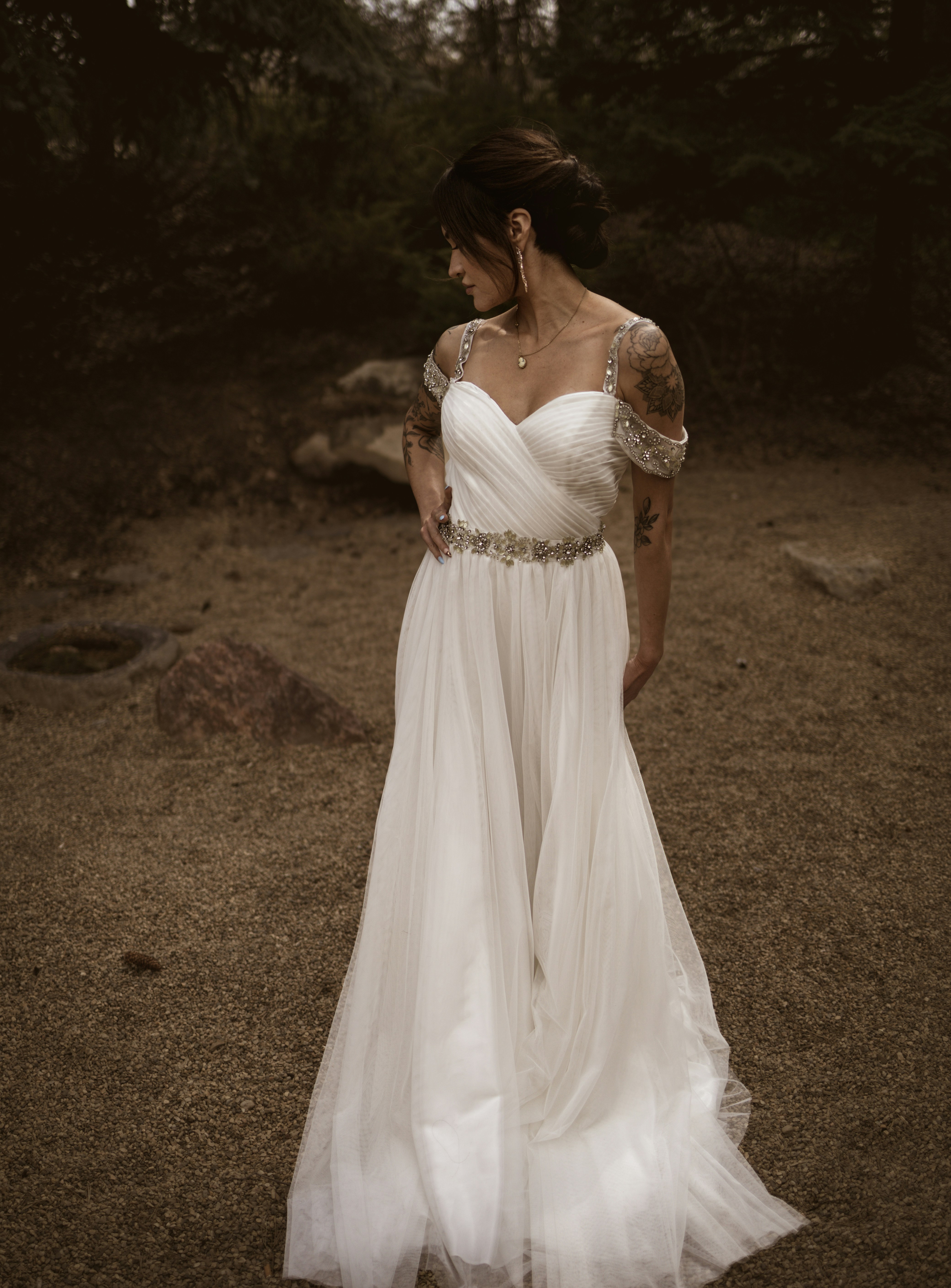 Bride in a white wedding dress standing outdoors