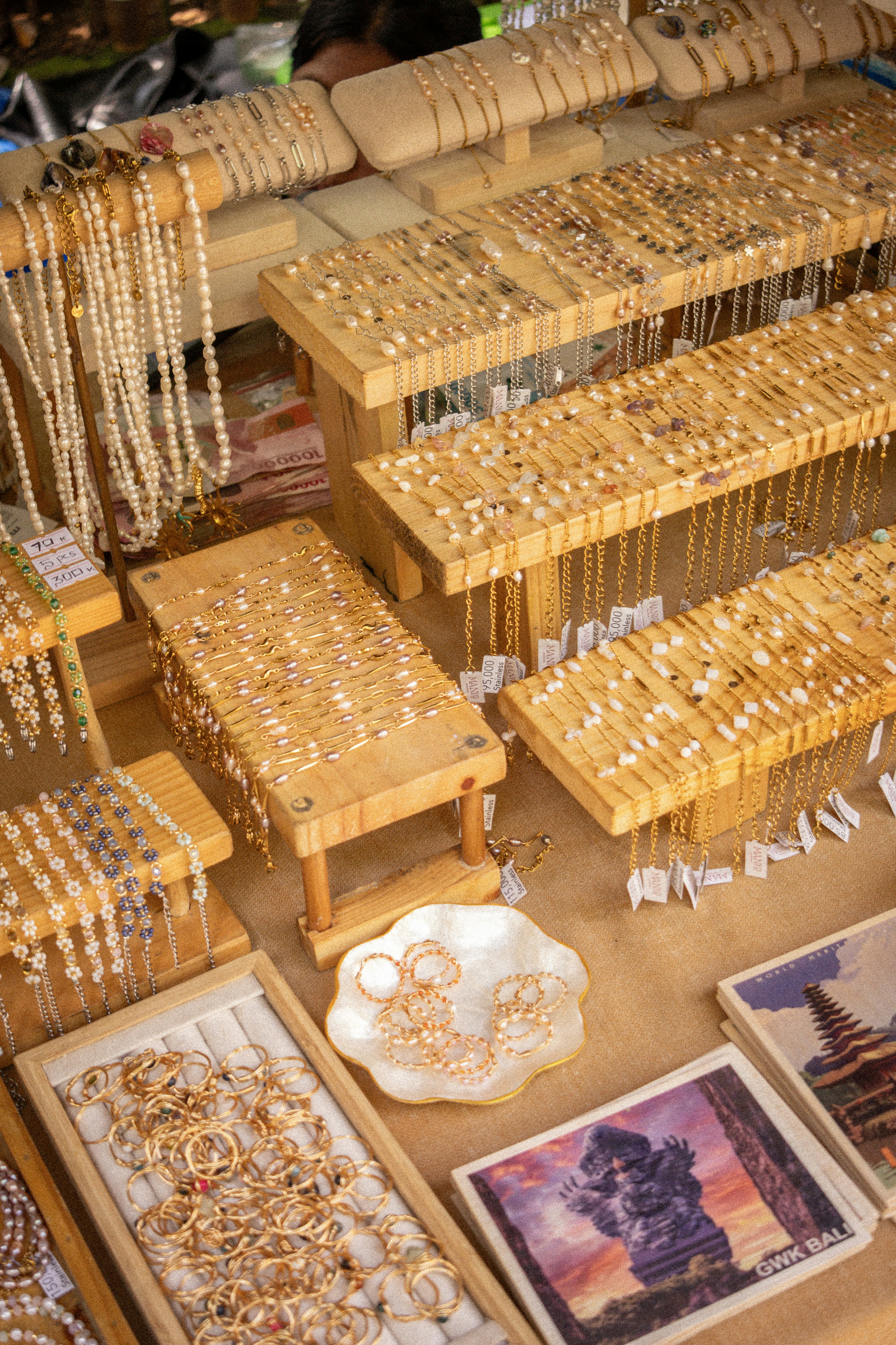 A market stall displaying various gold and pearl jewelry.