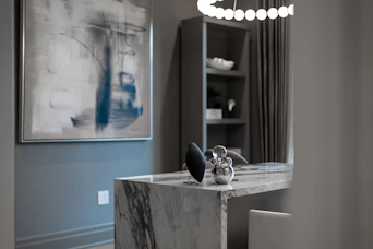 Modern office with marble desk and abstract art