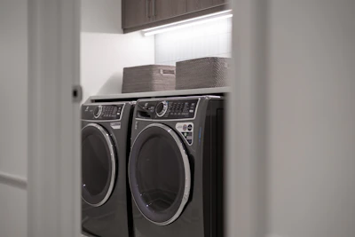 Modern laundry room with matching washer and dryer.
