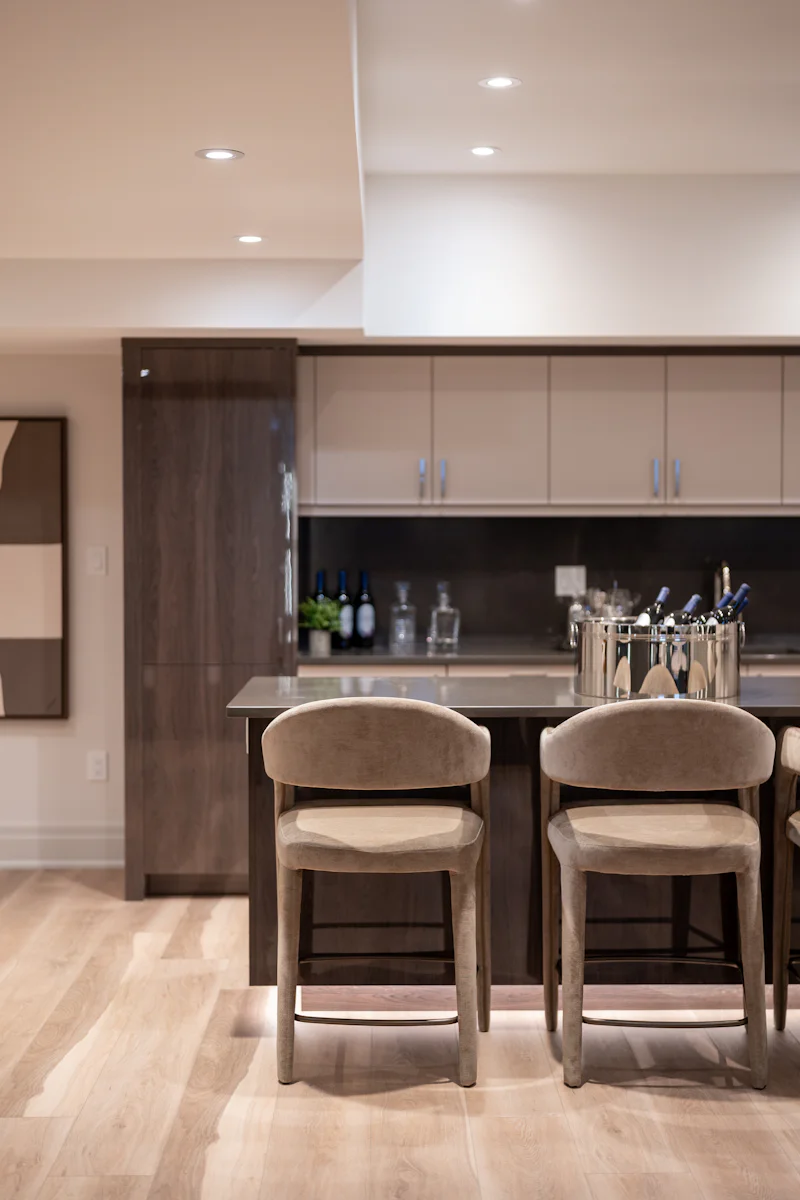 Modern kitchen island with two bar stools and wine cooler