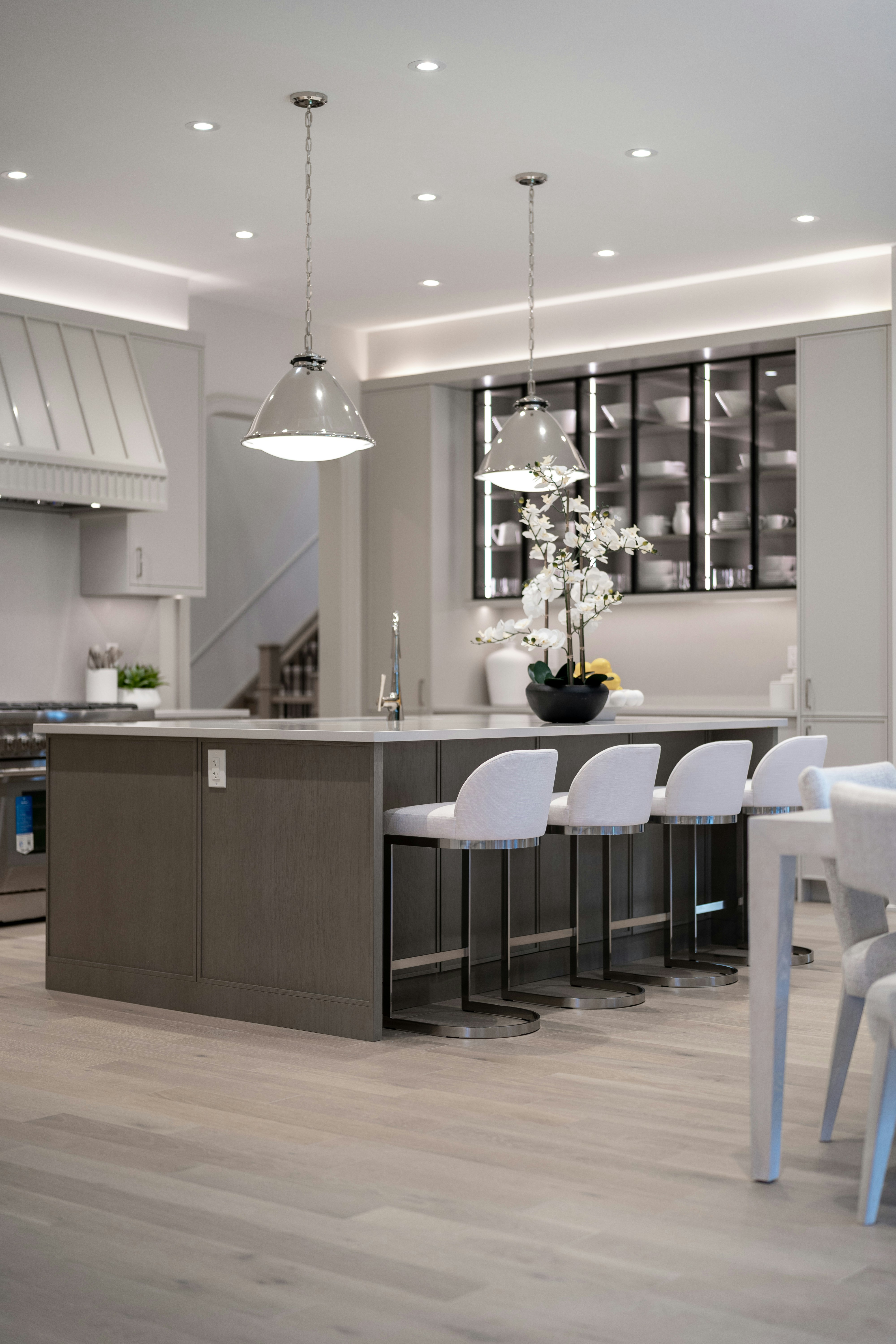 Bright, modern kitchen with a central island and white seating.