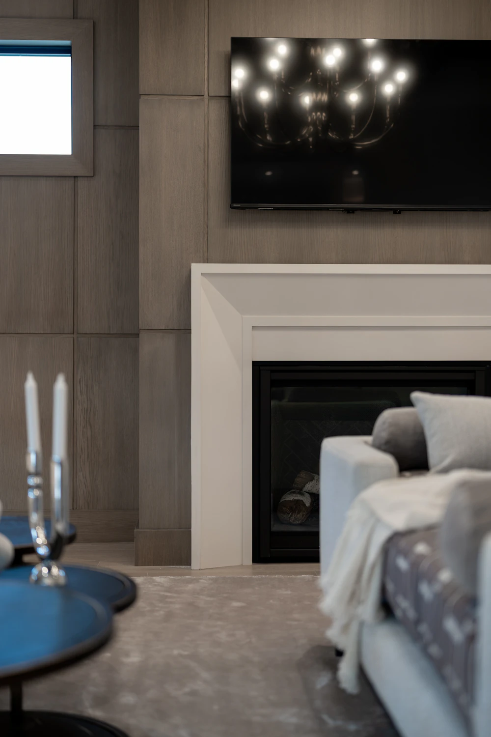 Living room with fireplace, millwork and warm lighting