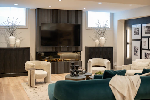 Modern living room with fireplace and comfortable seating.