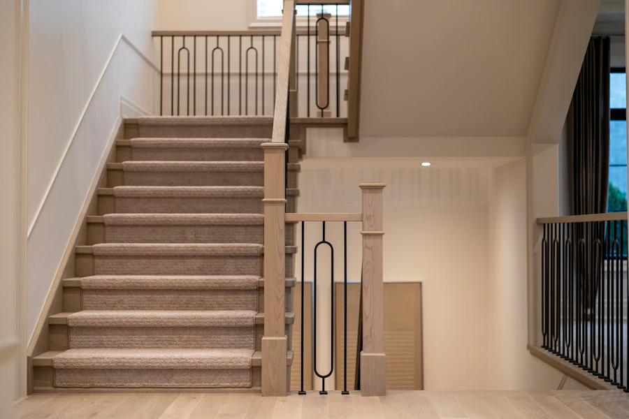 Modern residential staircase with dark metal balusters