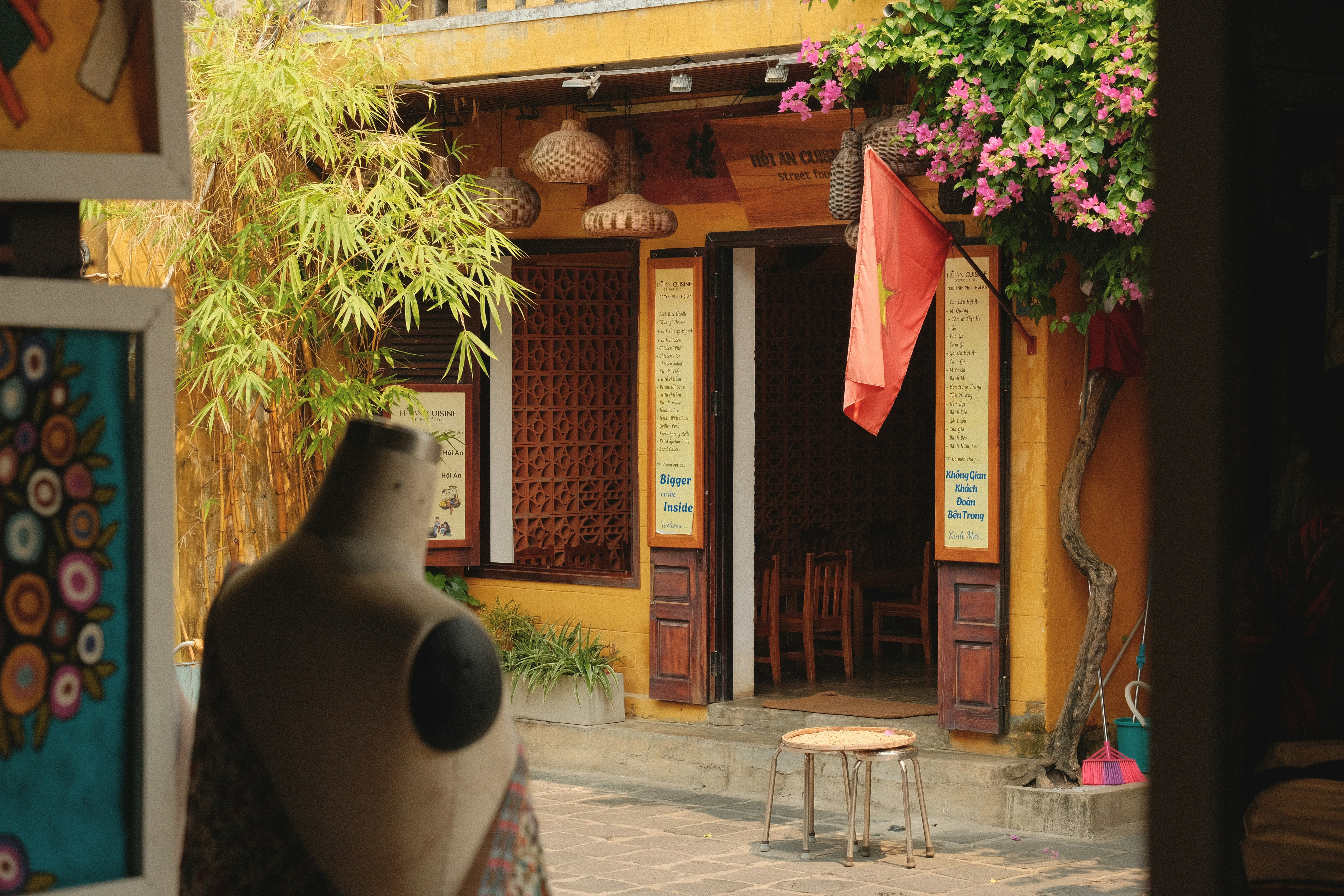 Yellow building with open doors and flowers