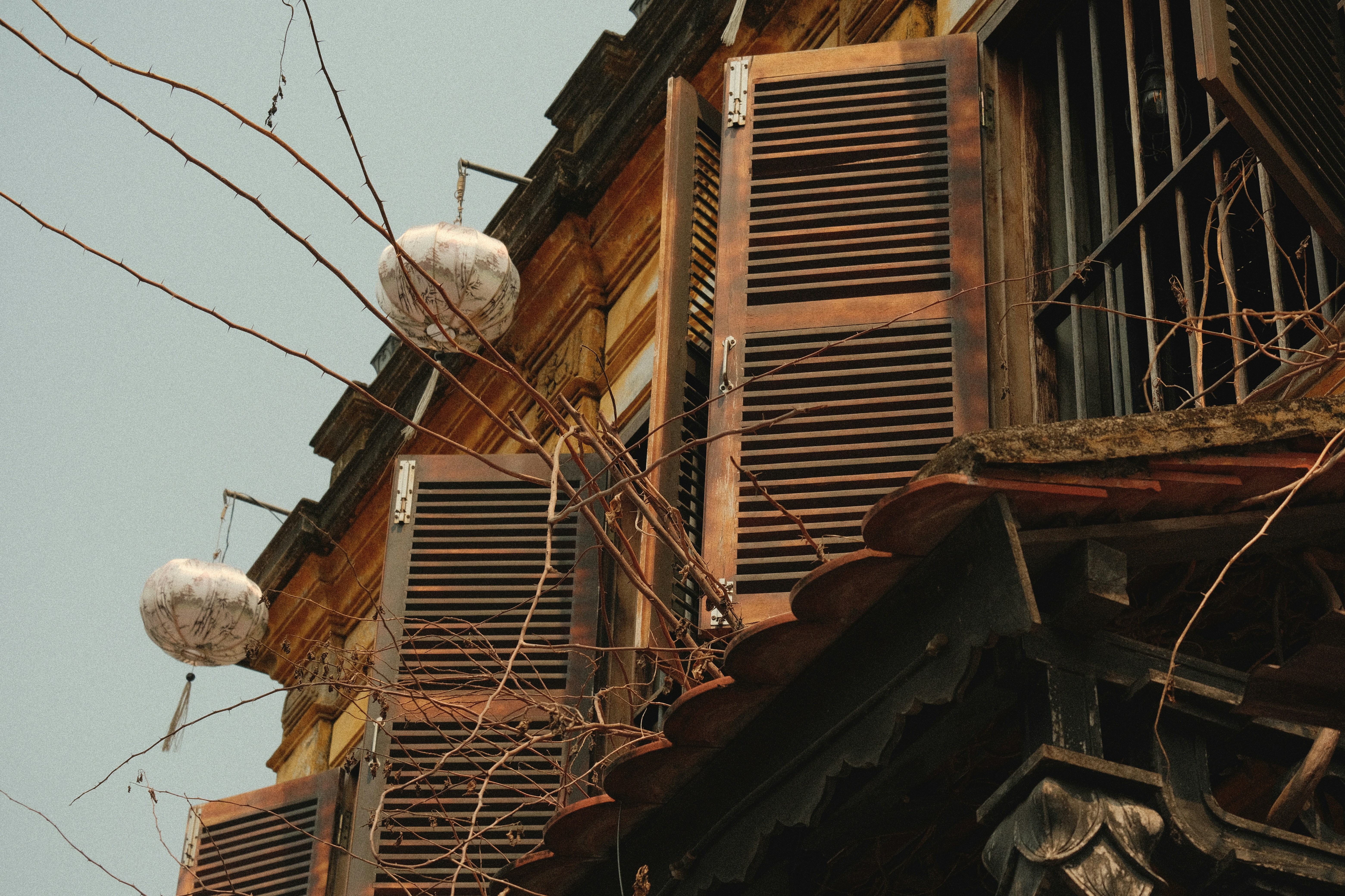 Weathered wooden shutters on an old building exterior.