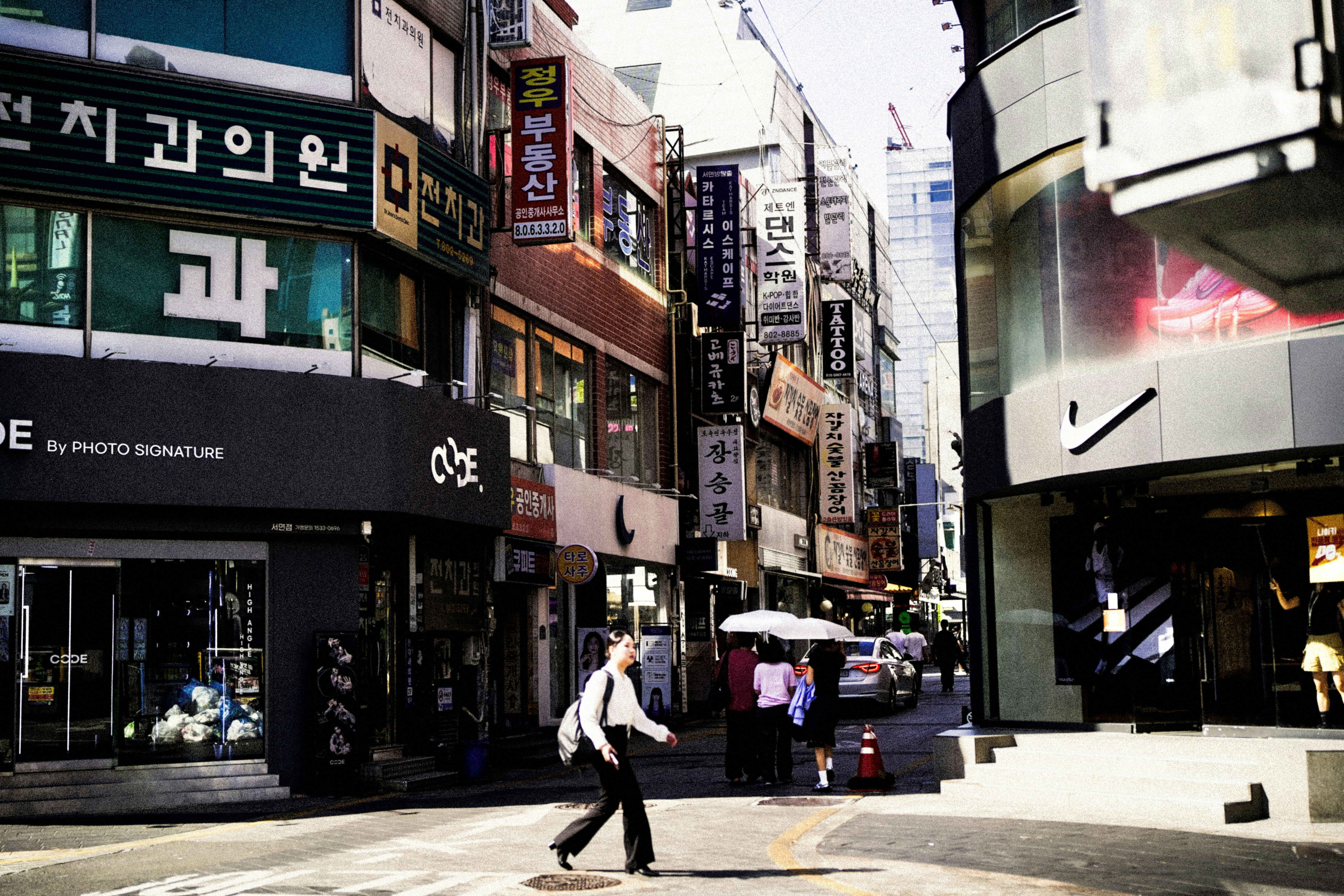 A person walks down a busy city street.