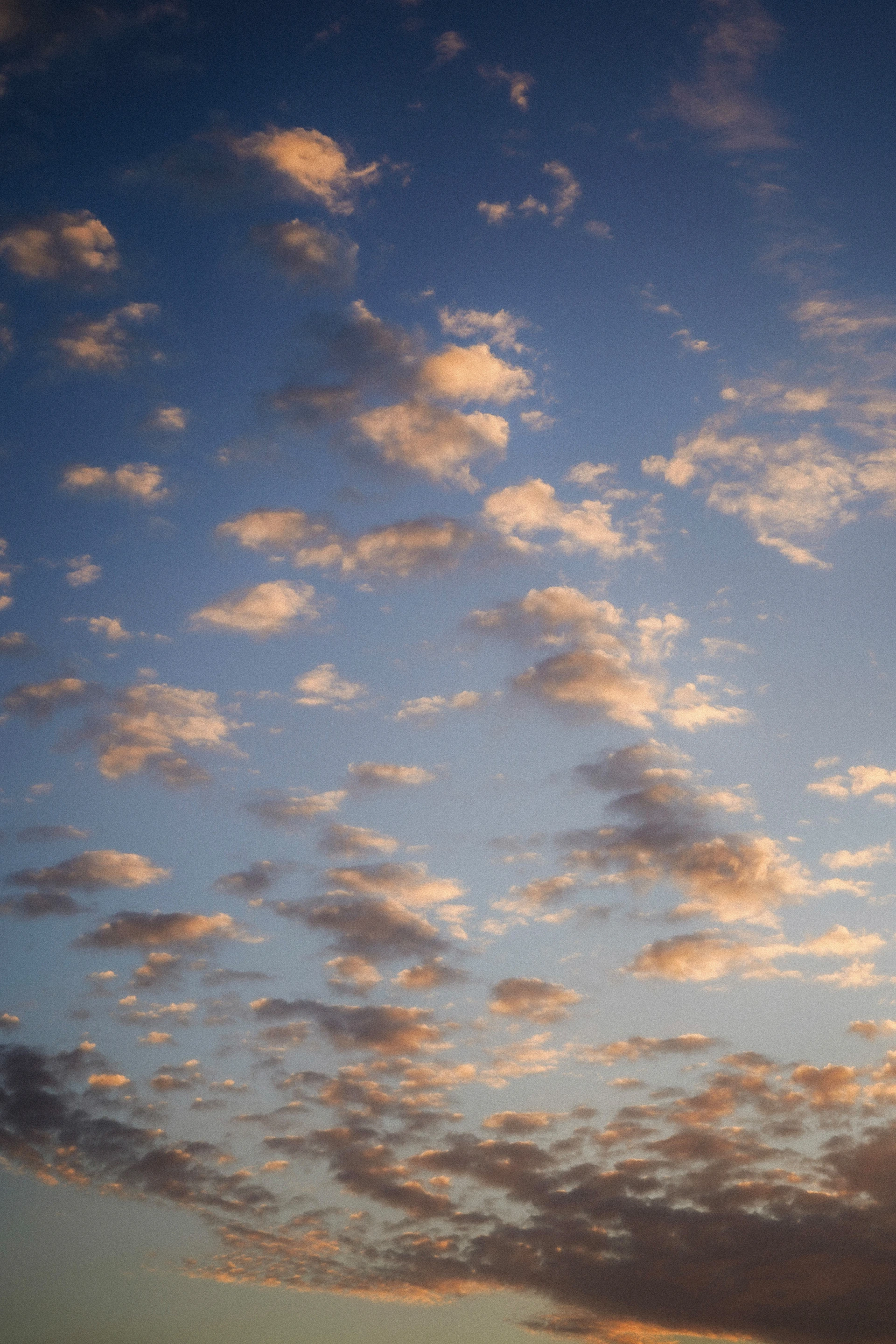 Scattered clouds in a blue sky at sunset