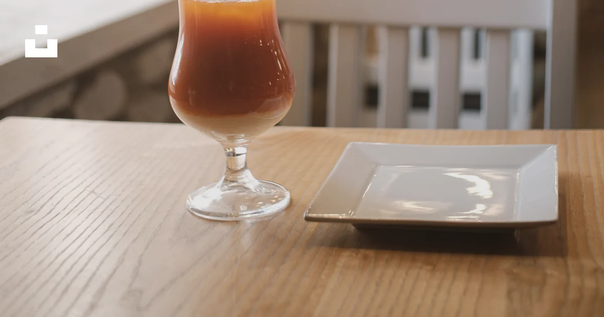 Table Glass Fitting Tools A tall glass of iced tea on a wooden table - Free Photo on Unsplash