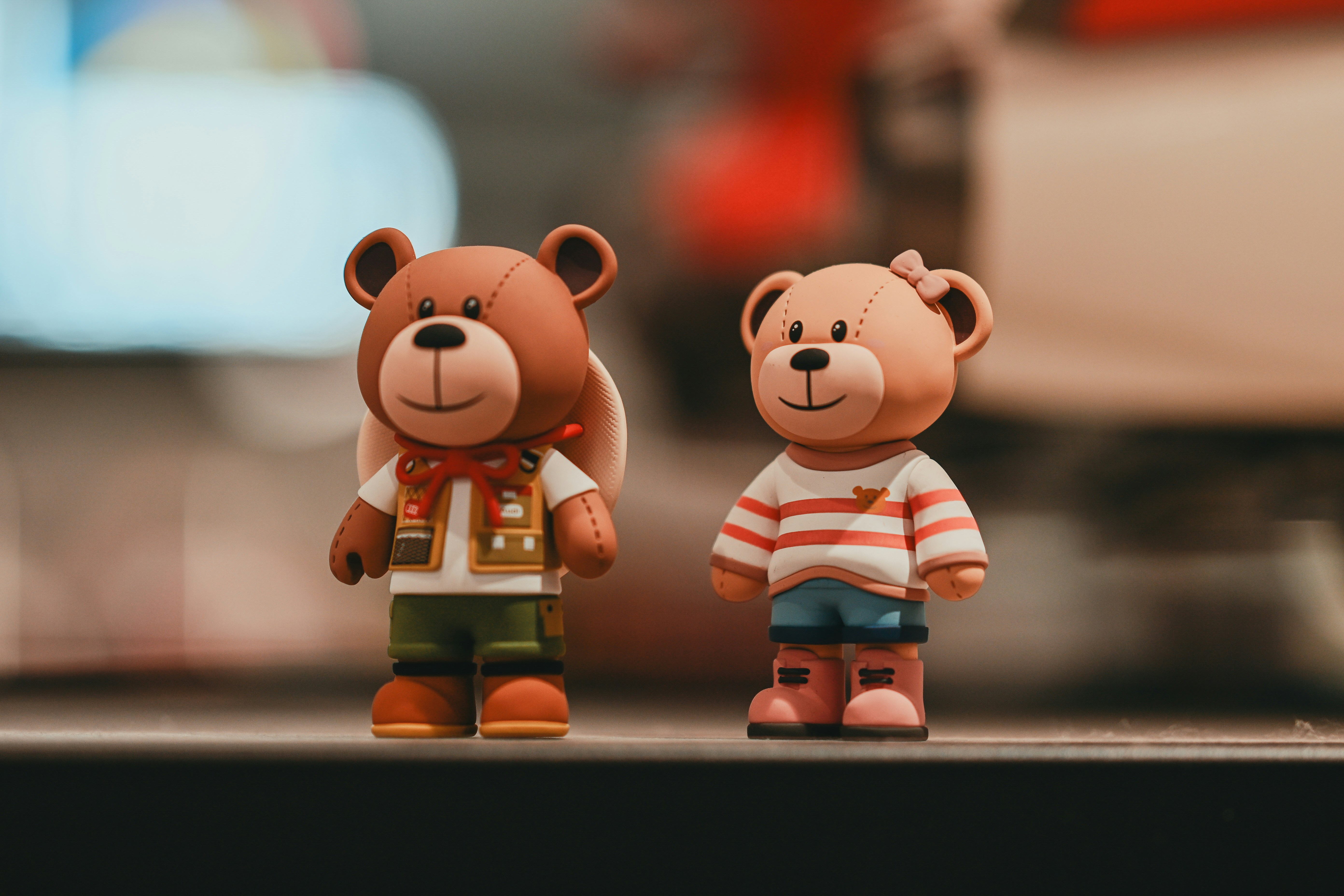 Two teddy bear figurines stand side by side.