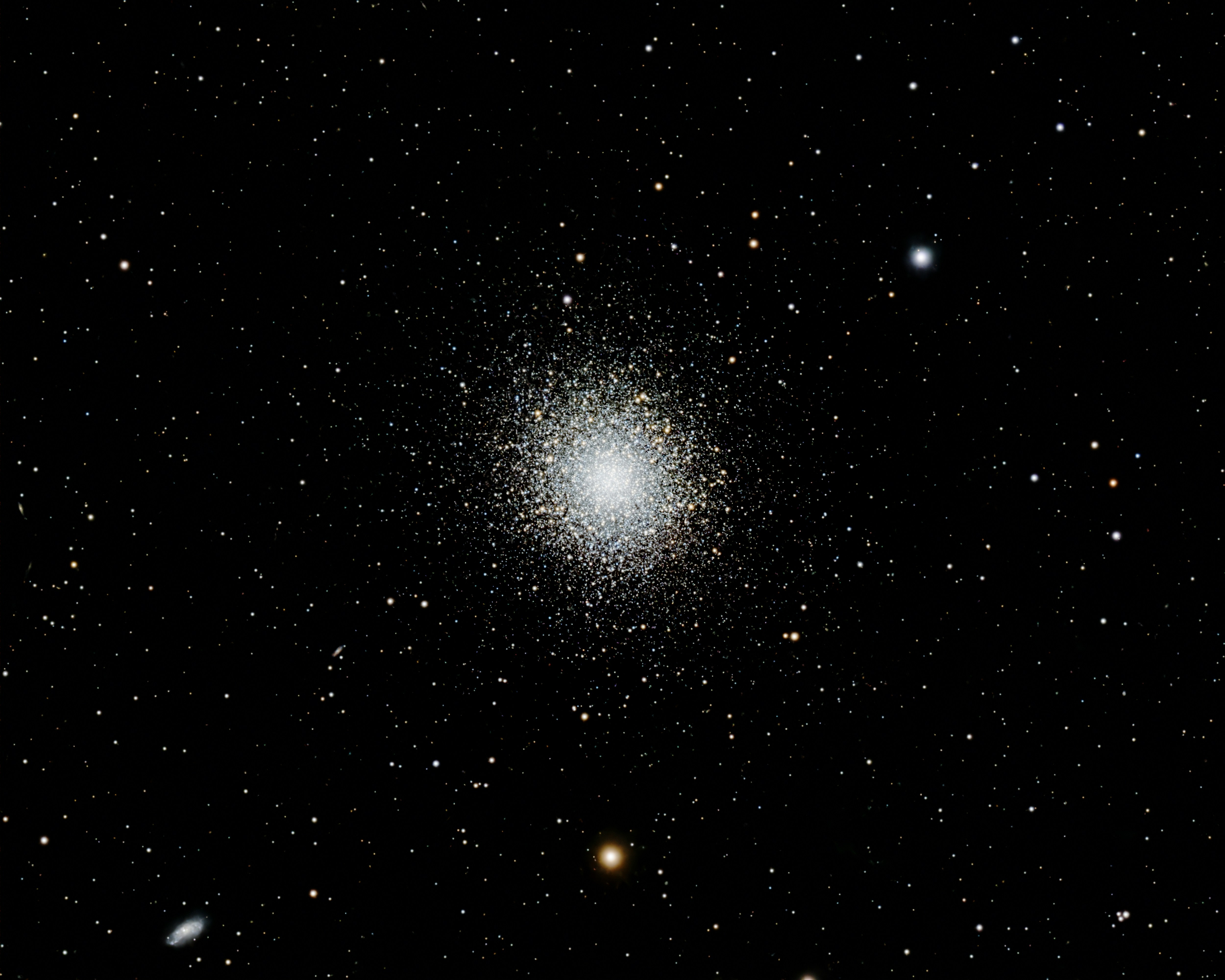 A dense globular star cluster shines brightly in deep space.