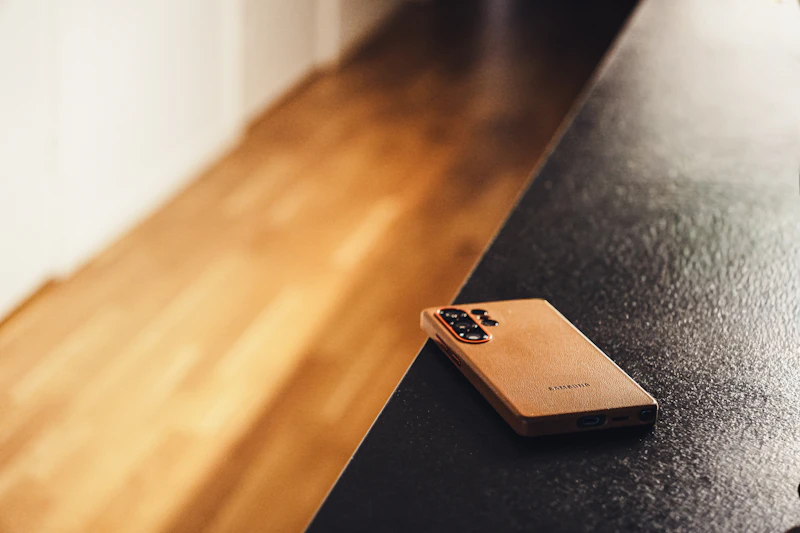 A Samsung Galaxy S25 Ultra lying on a dark surface