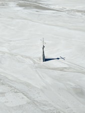 Church spire rising from a flooded mine tailings basin