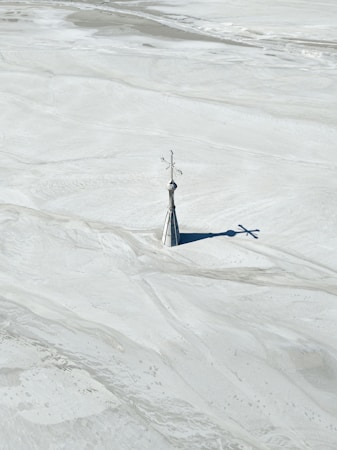 Church spire rising from a flooded mine tailings basin