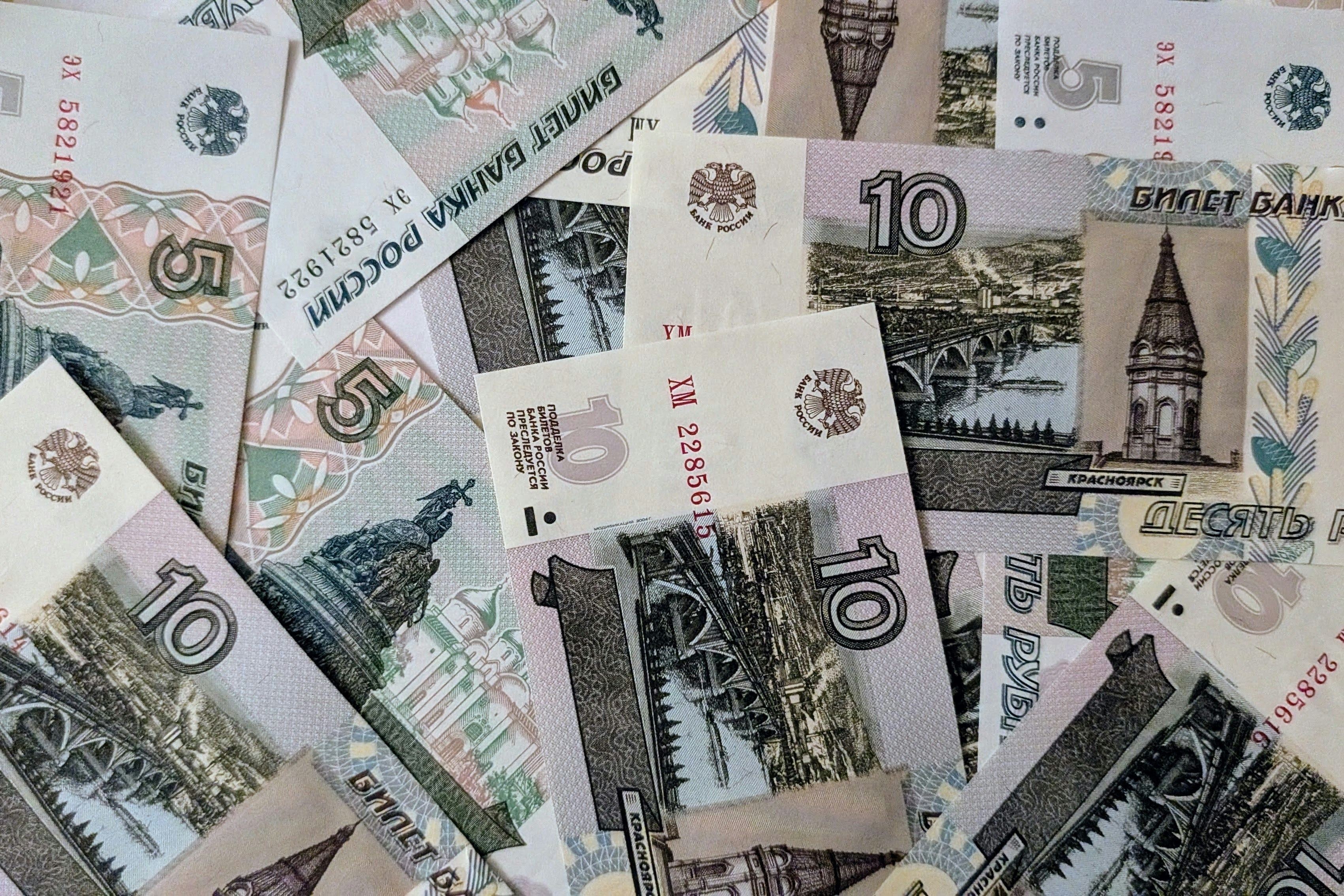 Scattered russian ruble banknotes, 5 and 10 denominations.