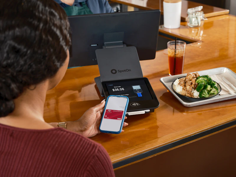 Customer tapping phone at a counter
