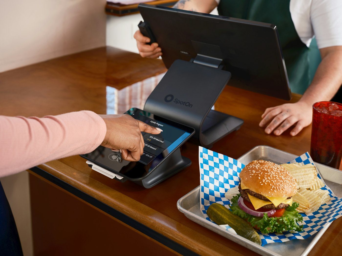 Customer paying with a card at a food counter