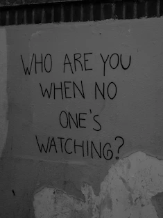 Graffiti asking "who are you when no one's watching?"