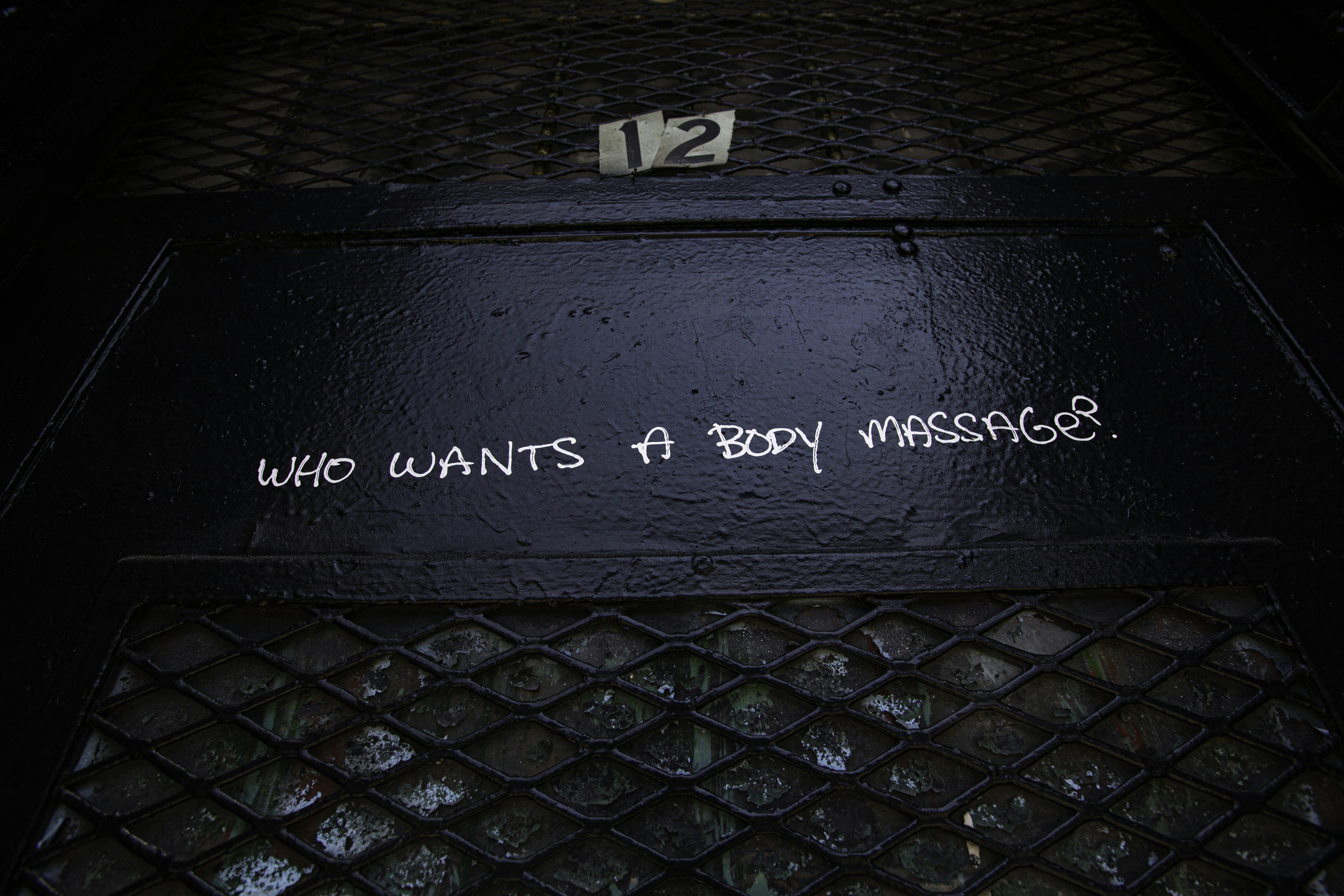 Black door with a question written on it.