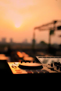 Dj equipment set up against a sunset backdrop