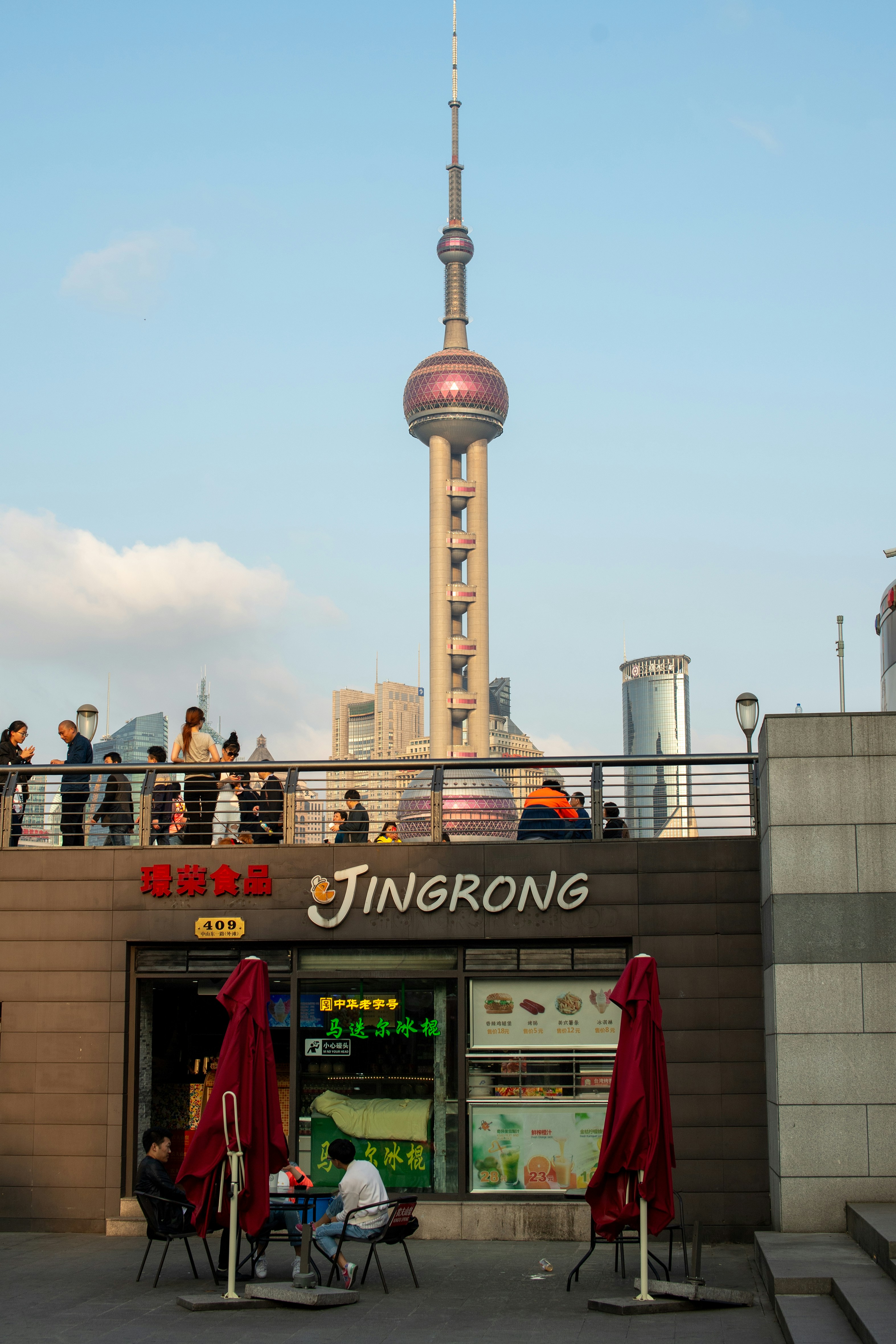 Iconic oriental pearl tower overlooks a street-level restaurant