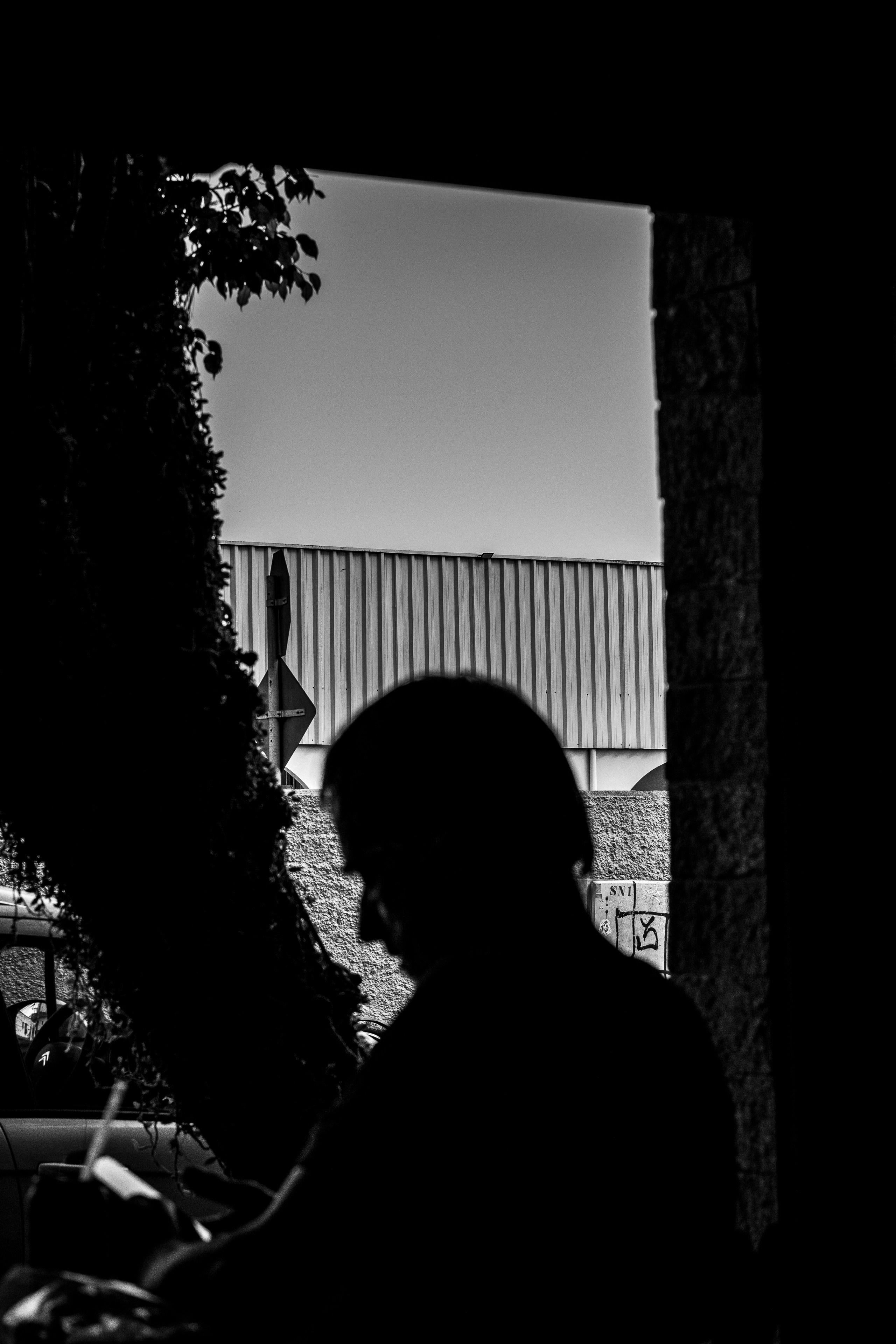 Silhouette of a person with a building in background