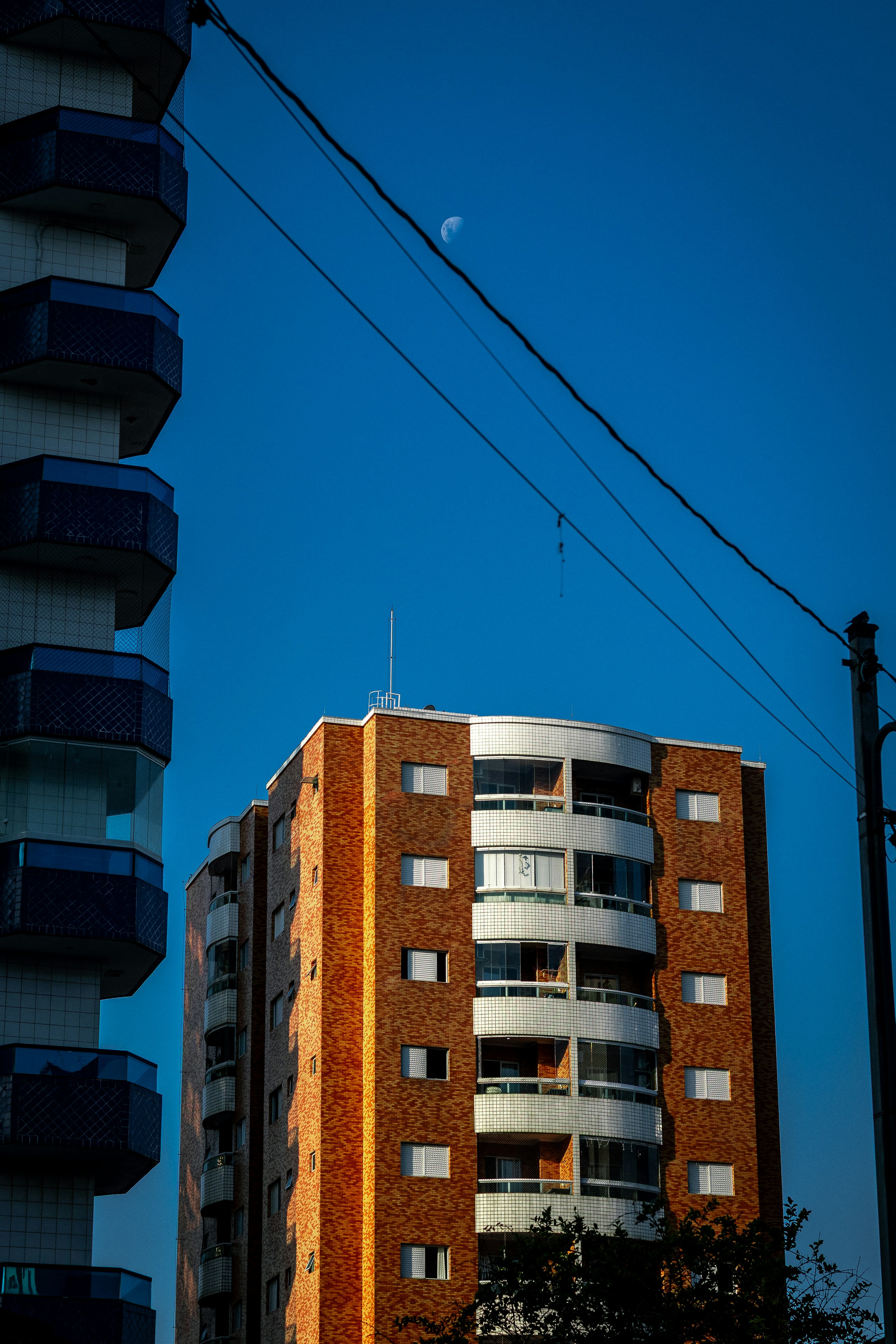 Apartment buildings against a clear blue sky.