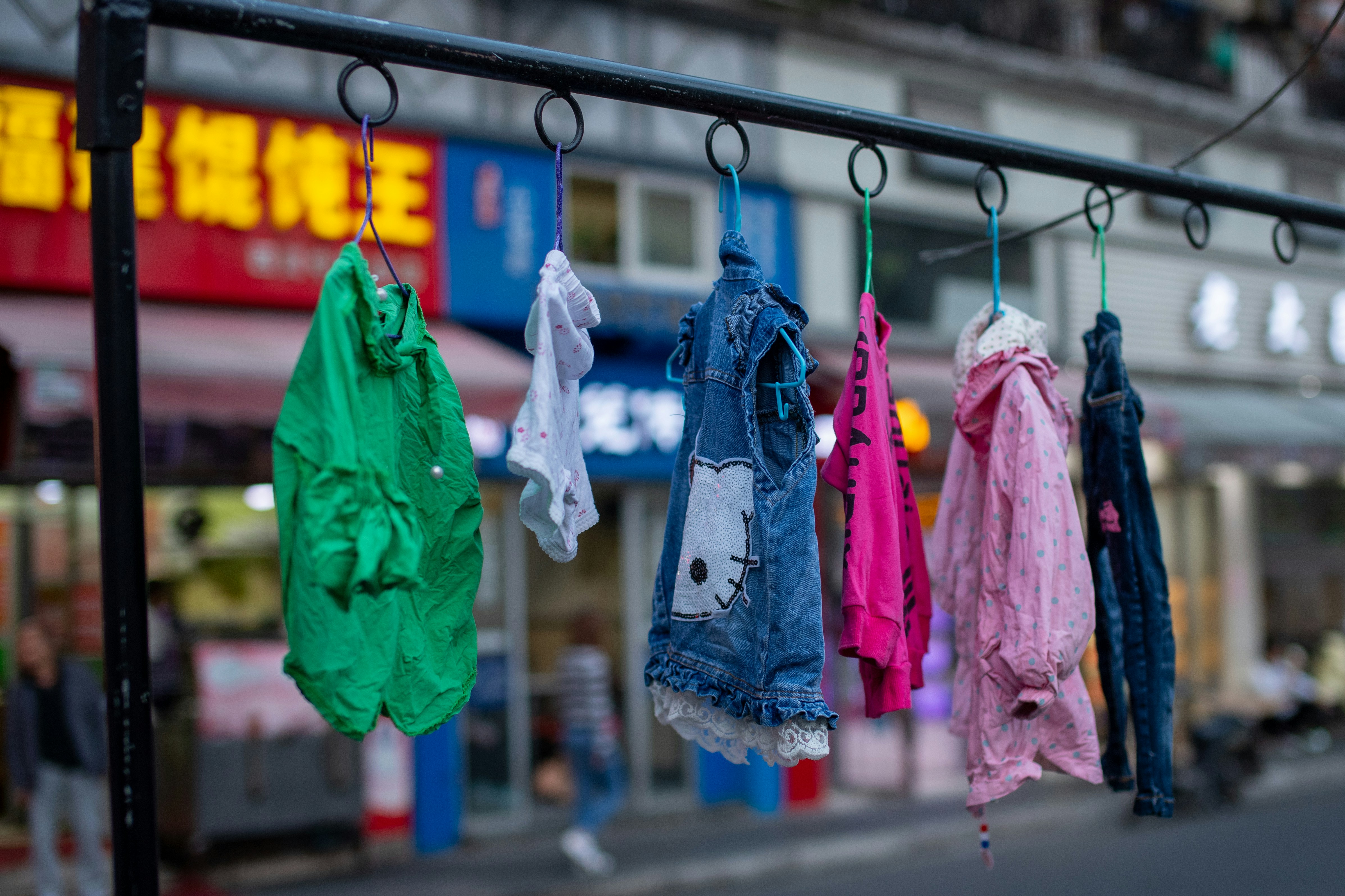 Colorful clothes hanging on a rack outdoors.