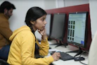 Young woman focused on computer screen in office