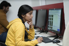Young woman focused on computer screen in office