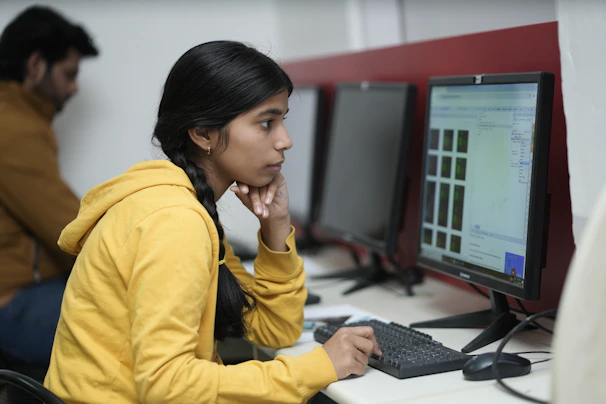 Young woman focused on computer screen in office