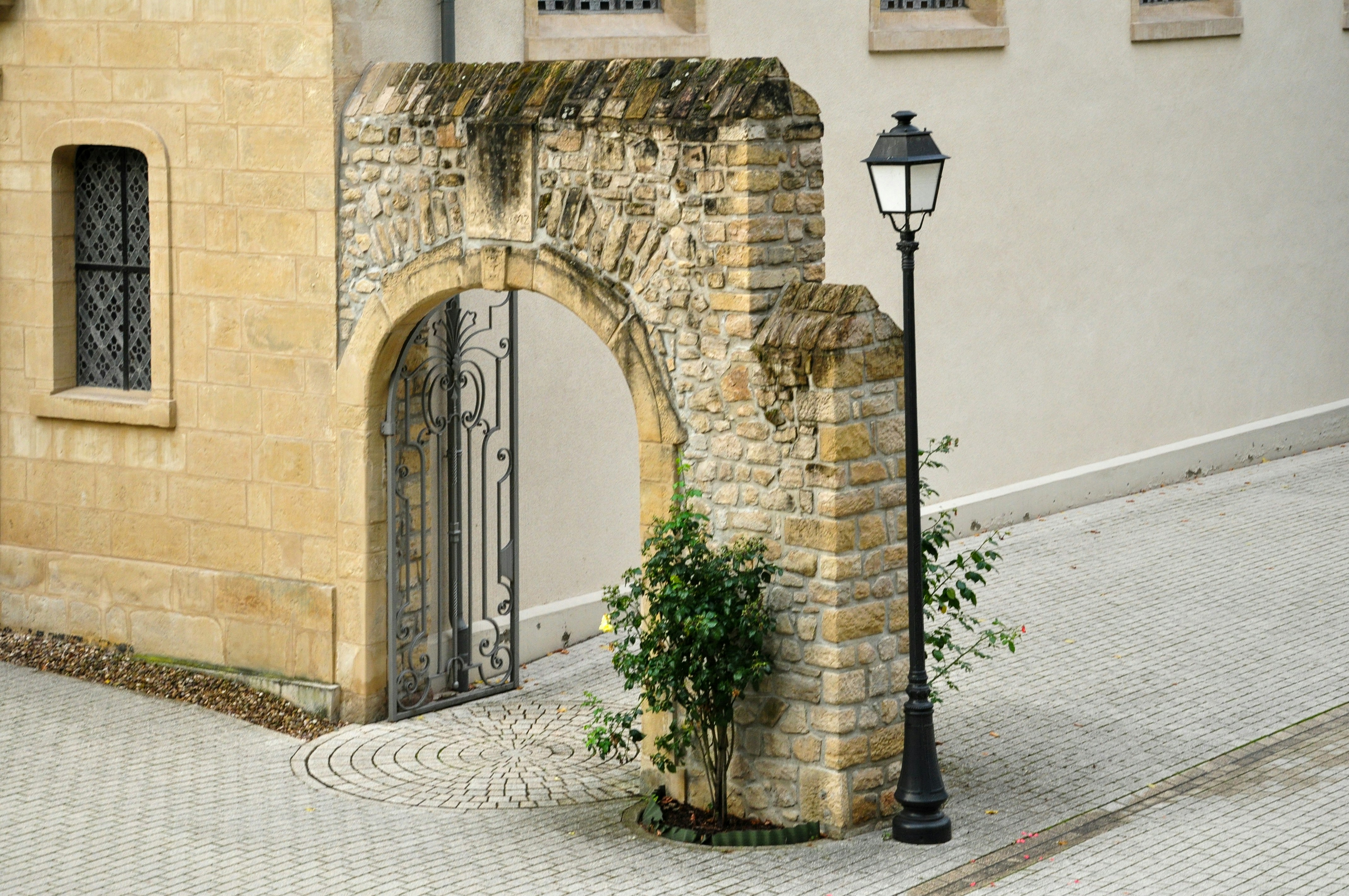 Stone archway with a vintage lamp post
