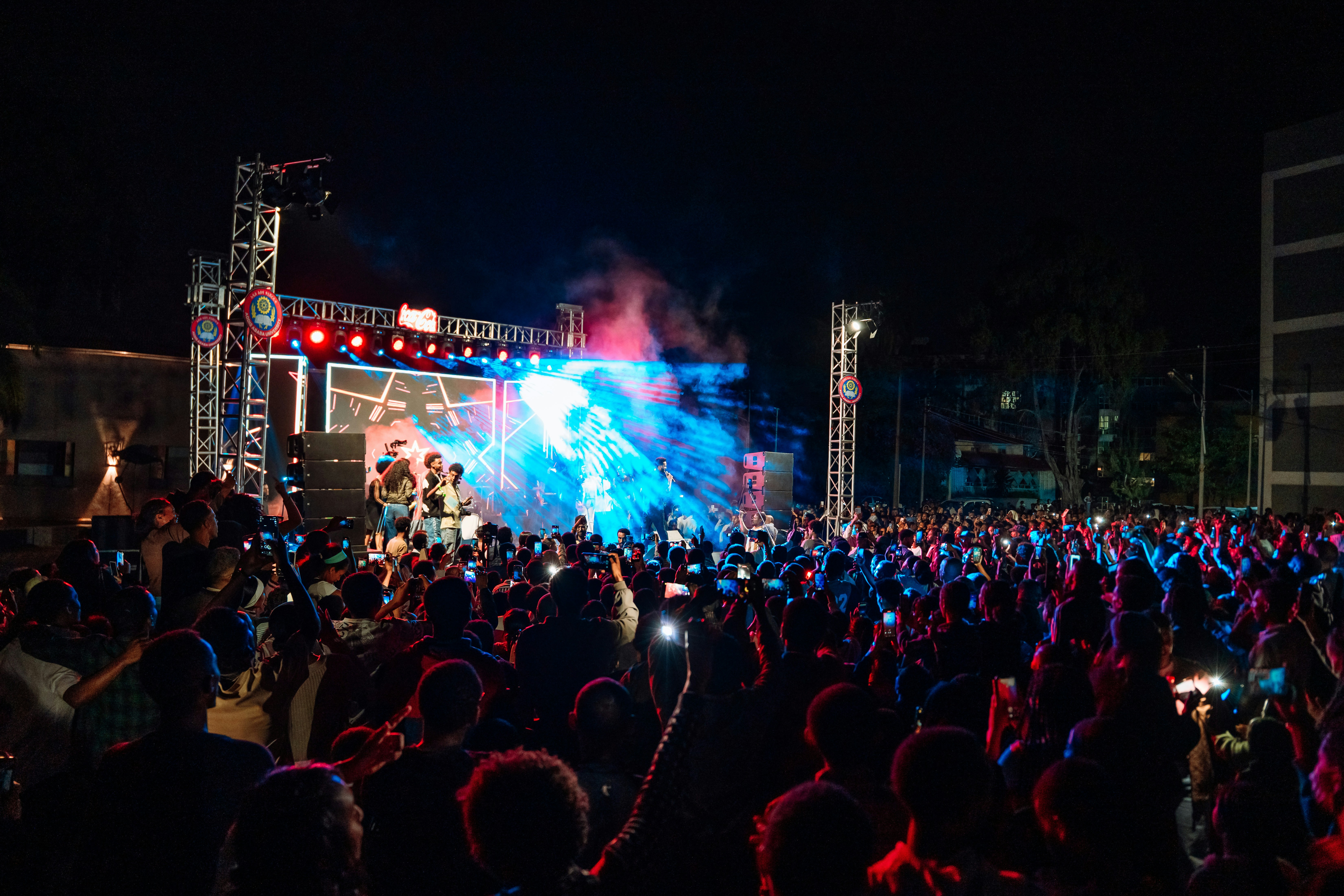 Crowd watching a concert with bright stage lights