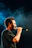 A man singing into a microphone on stage.