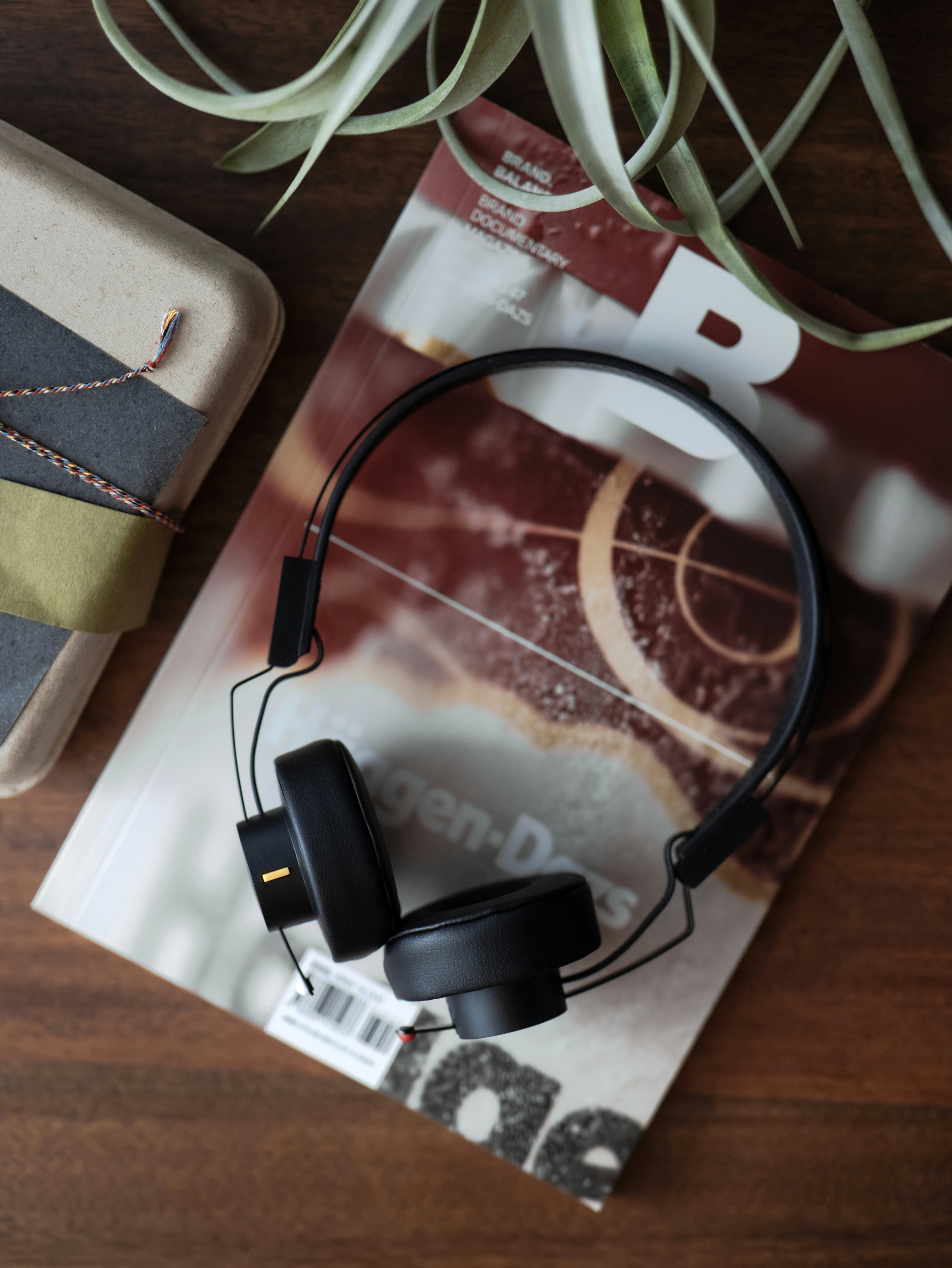 Black headphones resting on a magazine
